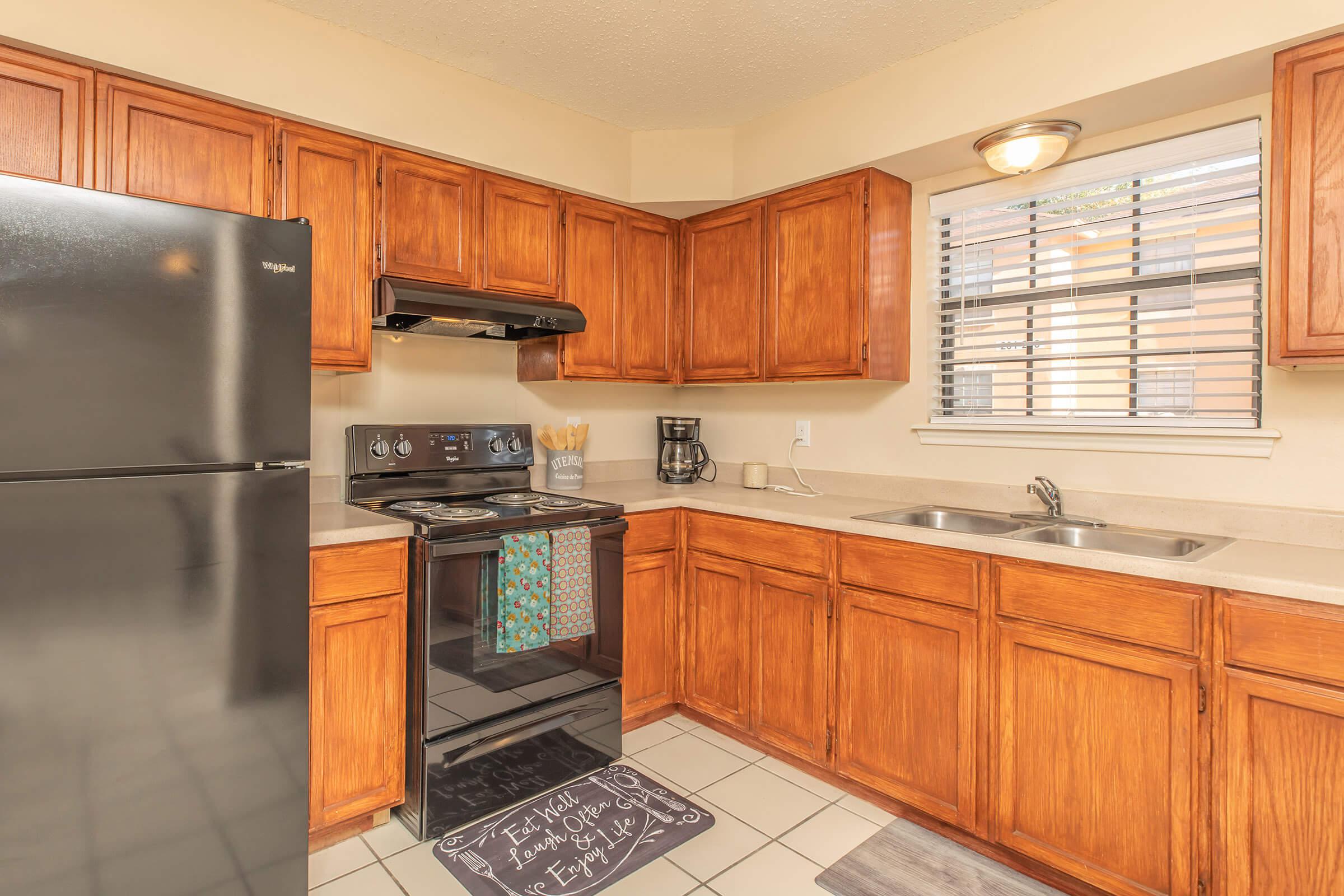 a kitchen with stainless steel appliances and wooden cabinets