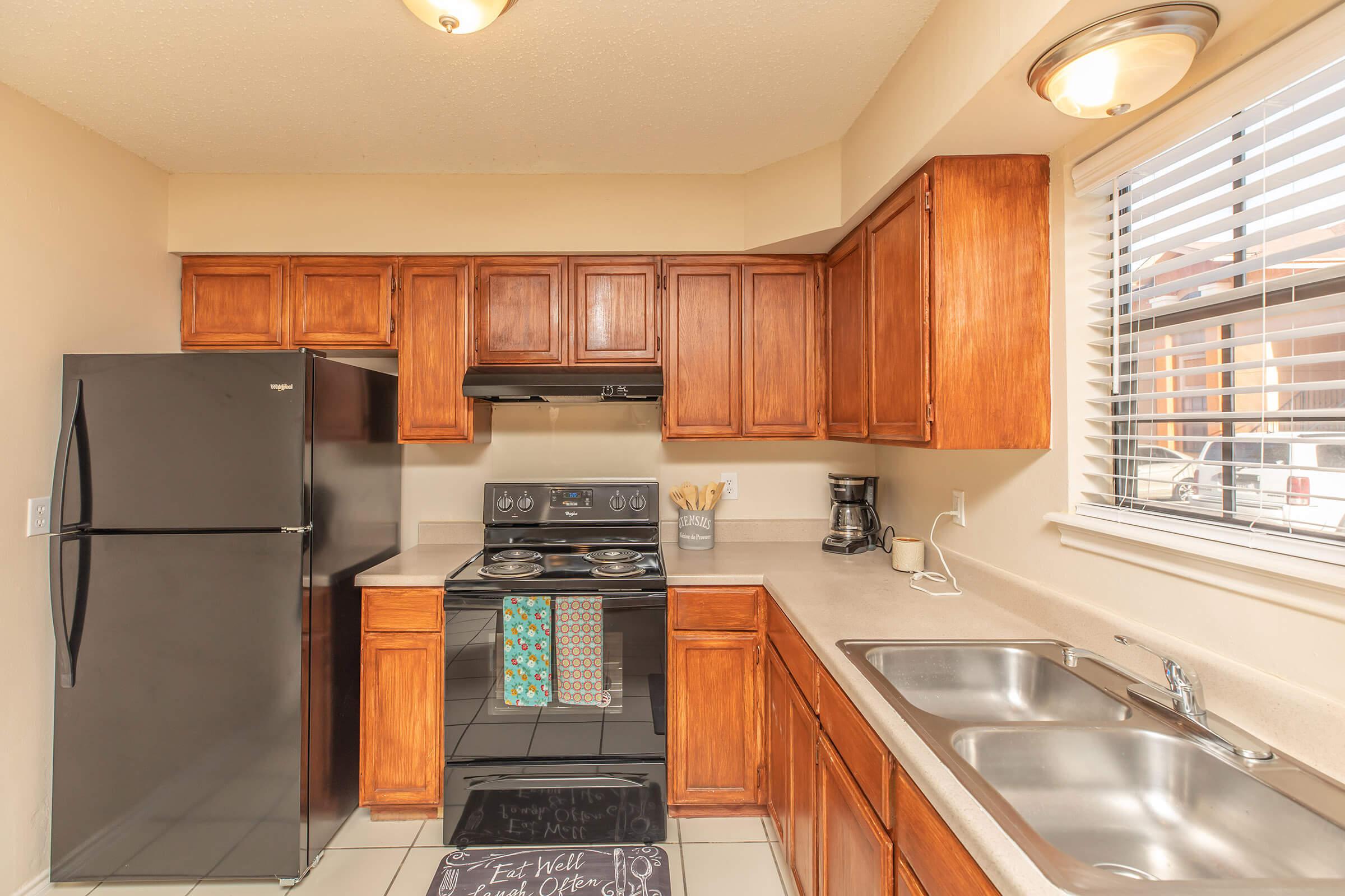 a modern kitchen with stainless steel appliances and wooden cabinets