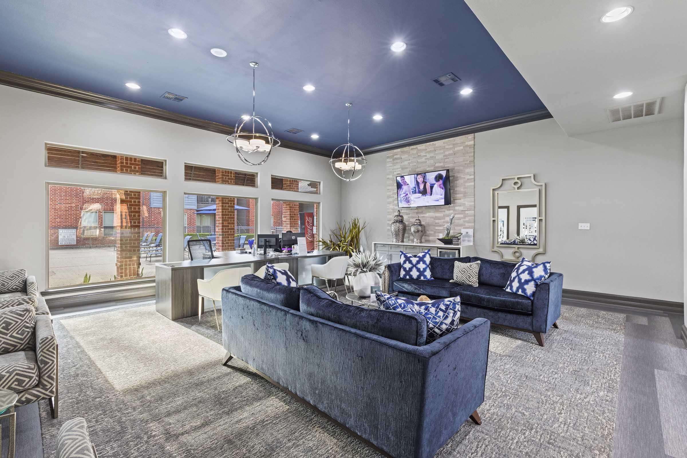 a living room filled with furniture and a large window