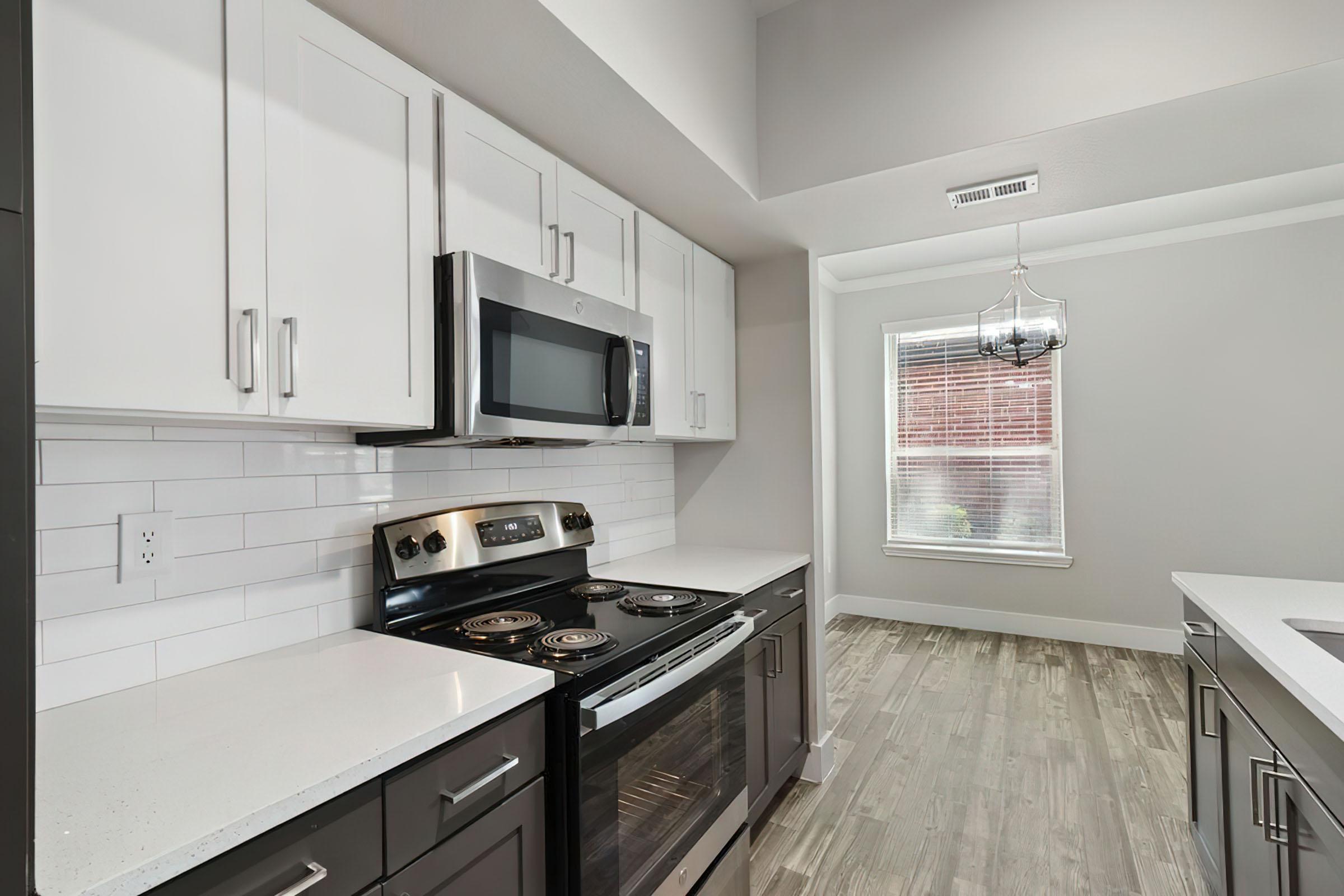 a stove top oven sitting inside of a kitchen