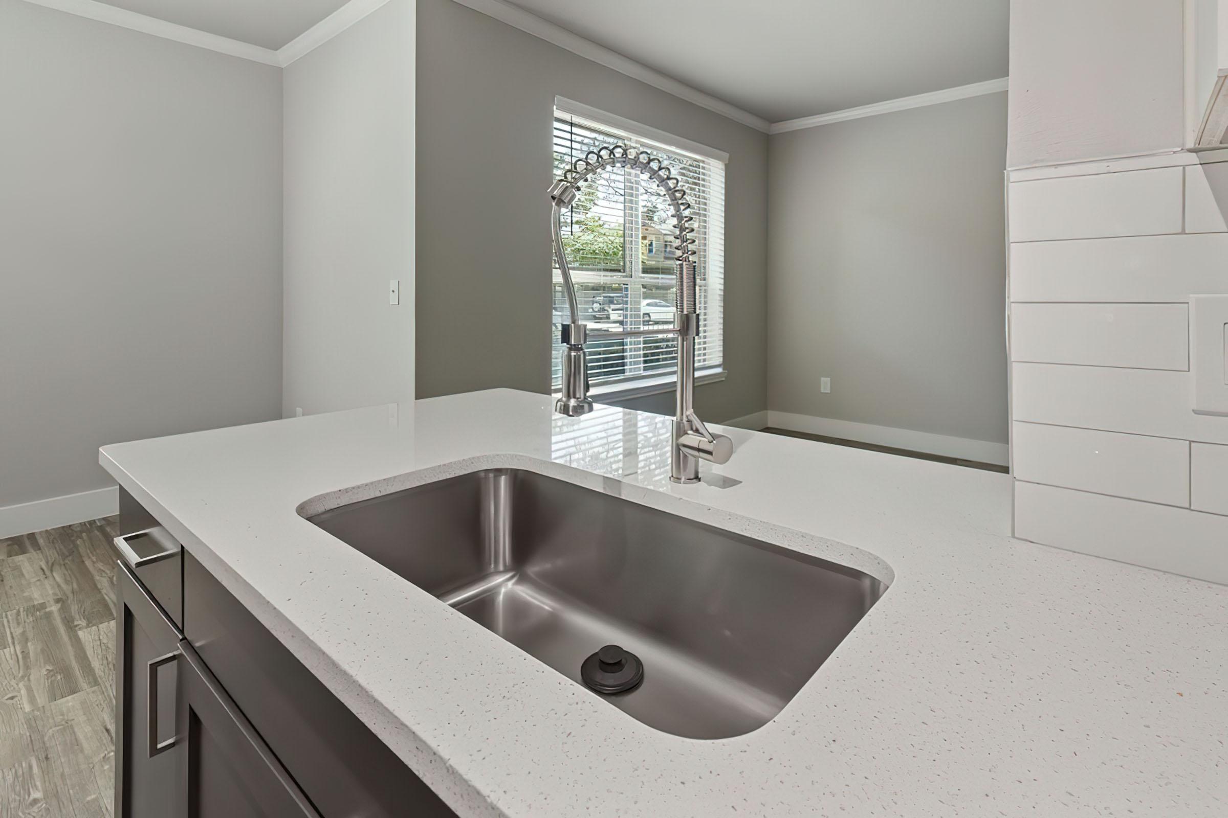 a kitchen with a sink and a mirror