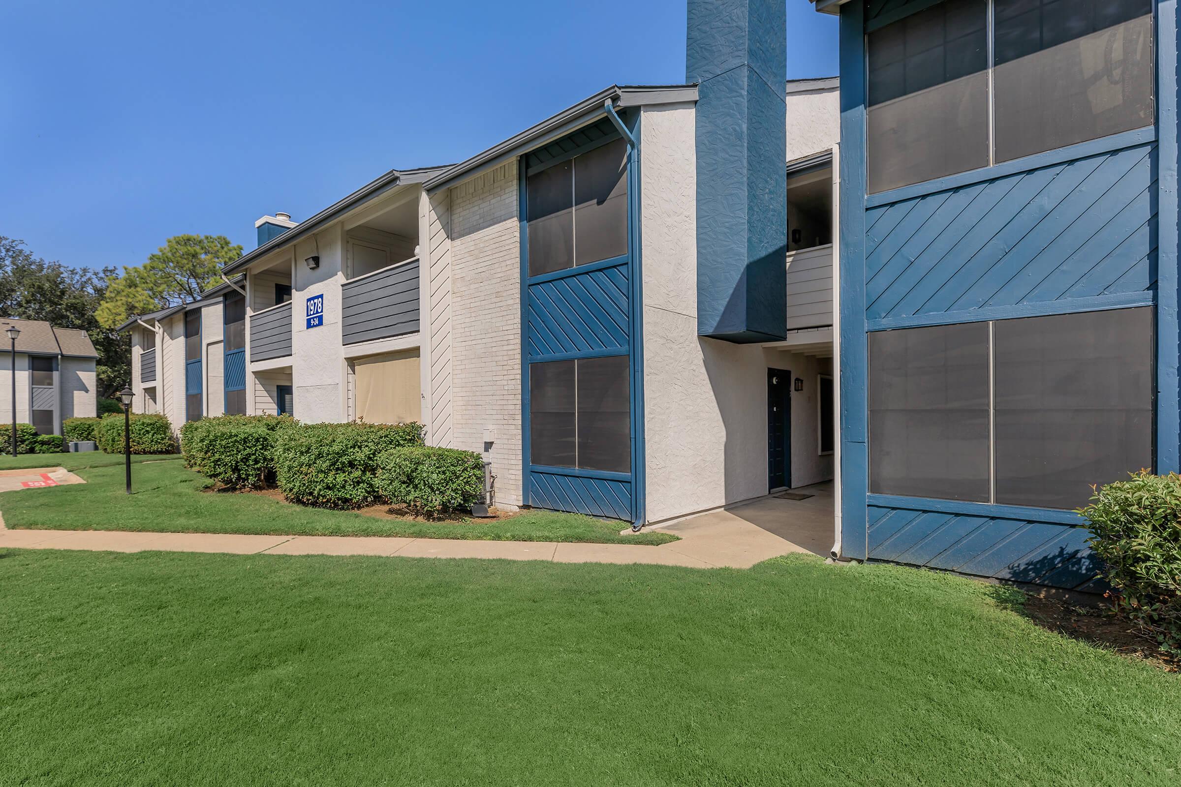 A landscaped pathway leading to the apartments at Rise Oak Creek