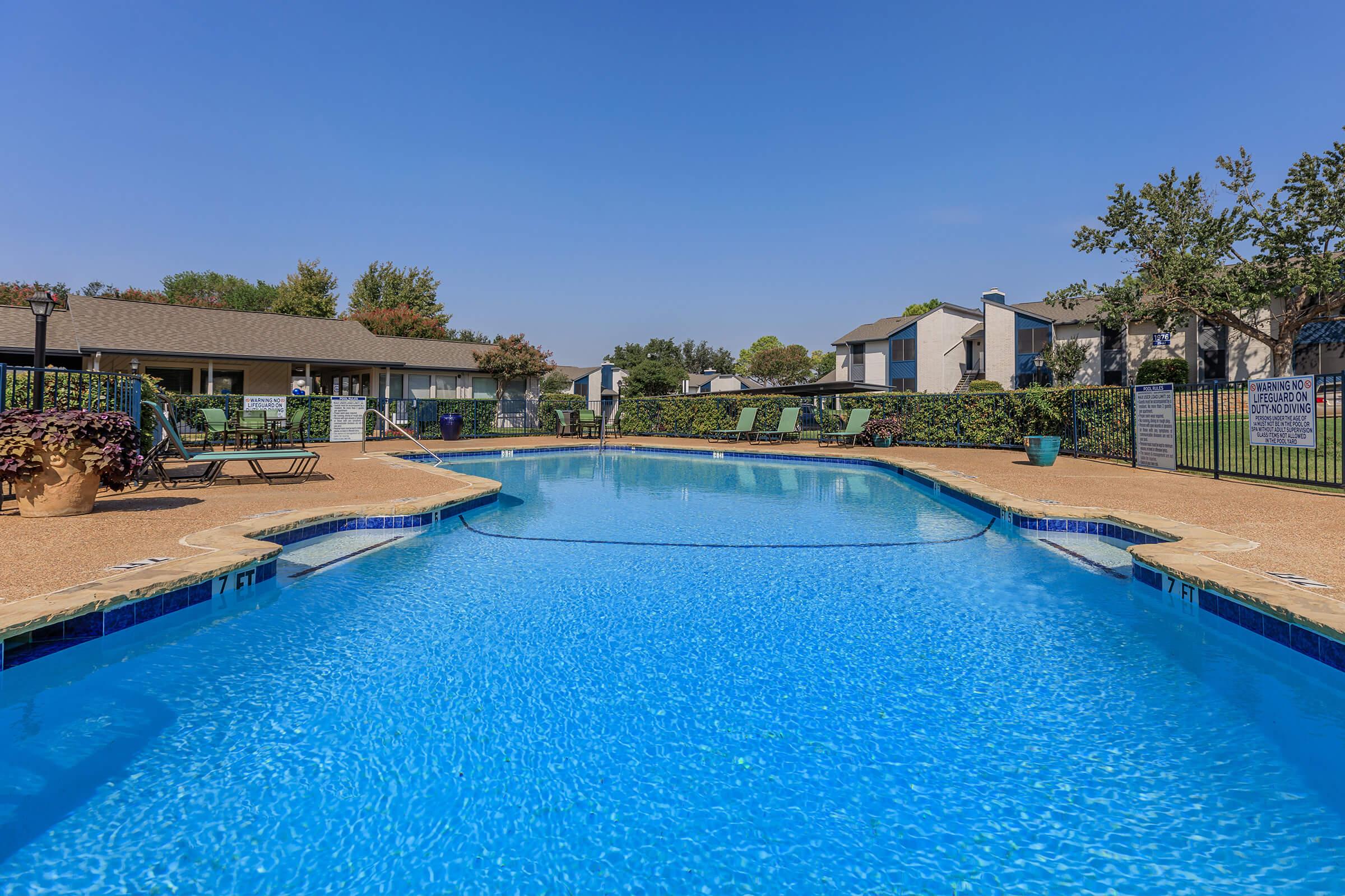 The dazzling pool with loungers at Rise Oak Creek, in Bedford, TX.