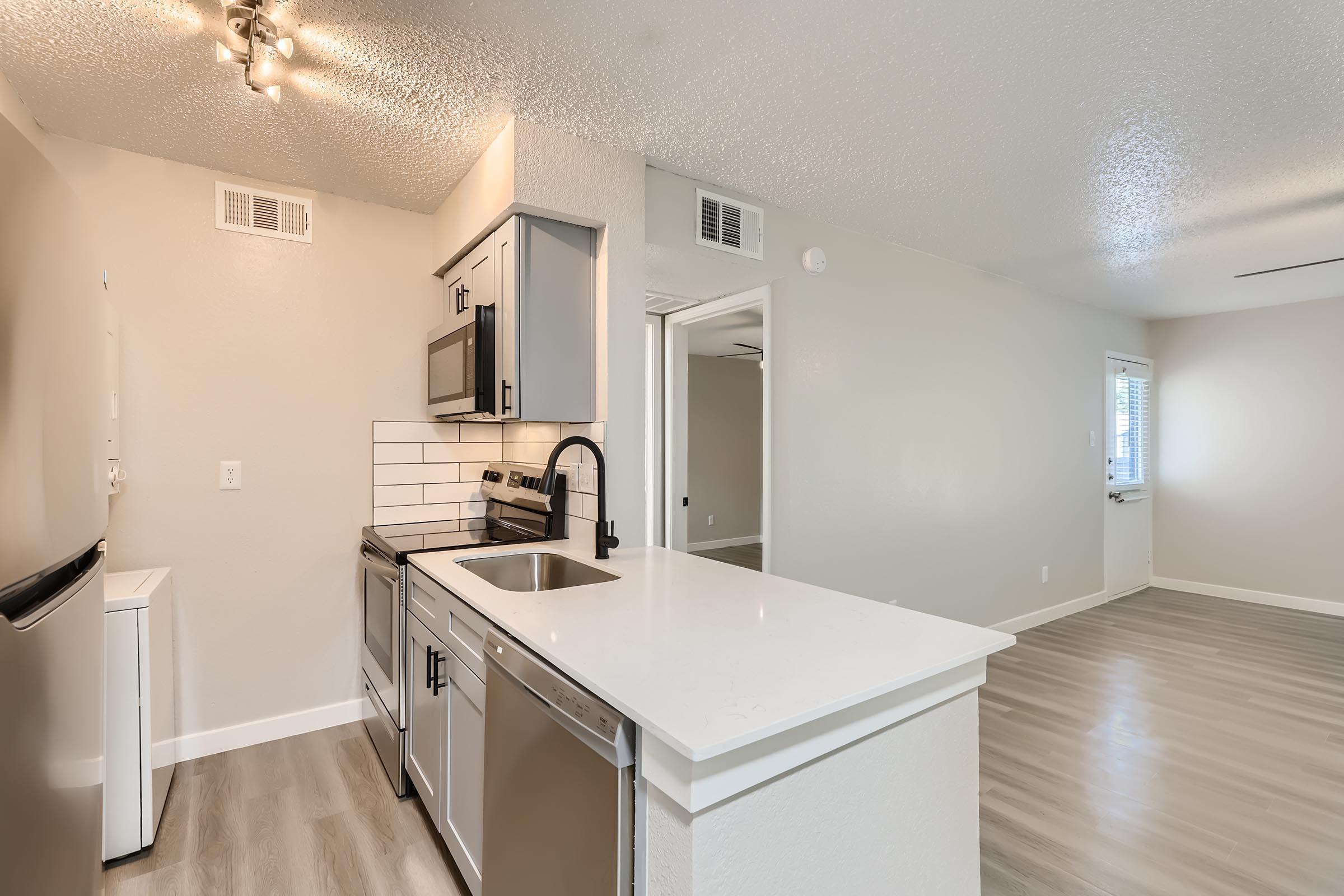 a kitchen with a sink and a mirror