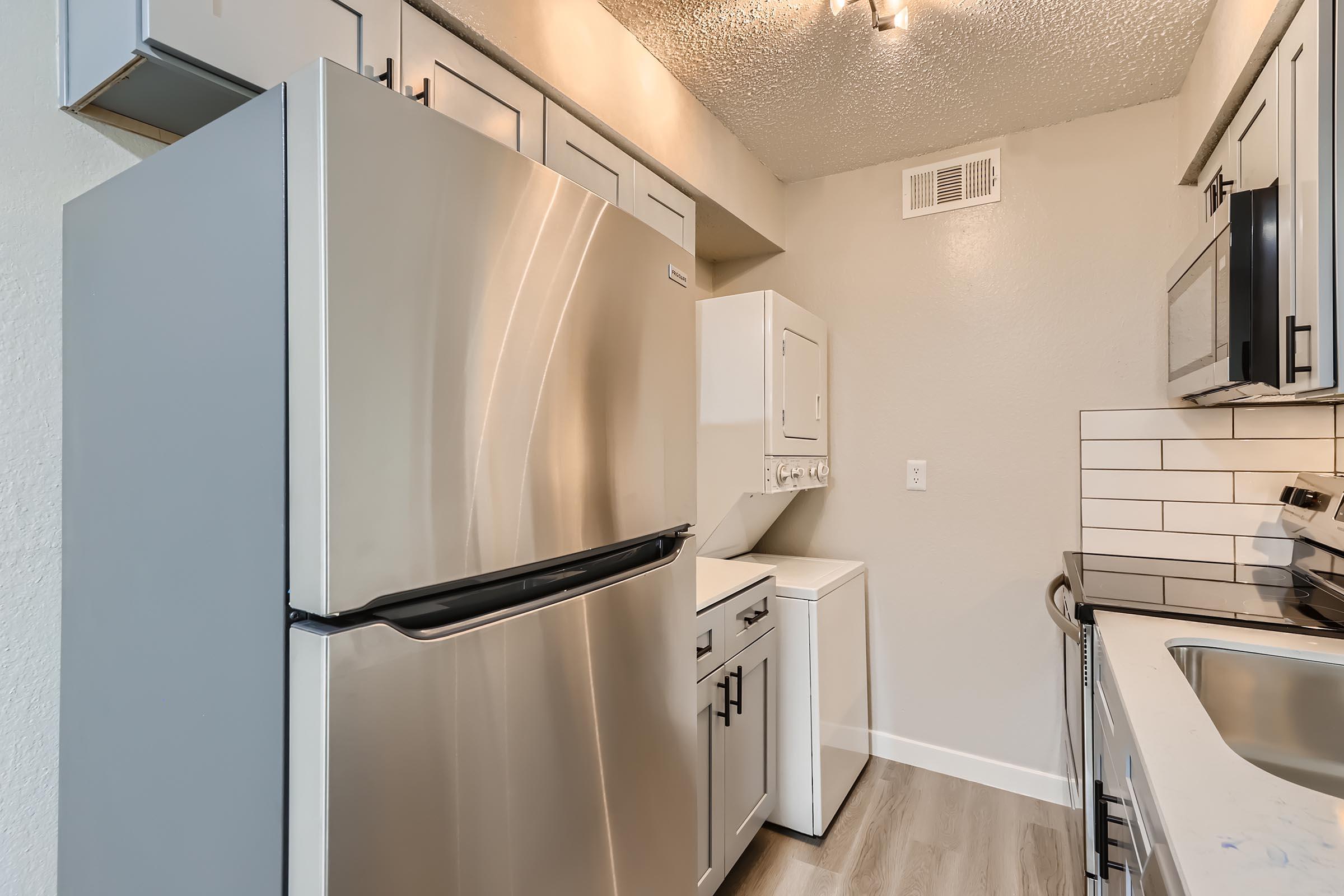 a kitchen with a sink and a mirror