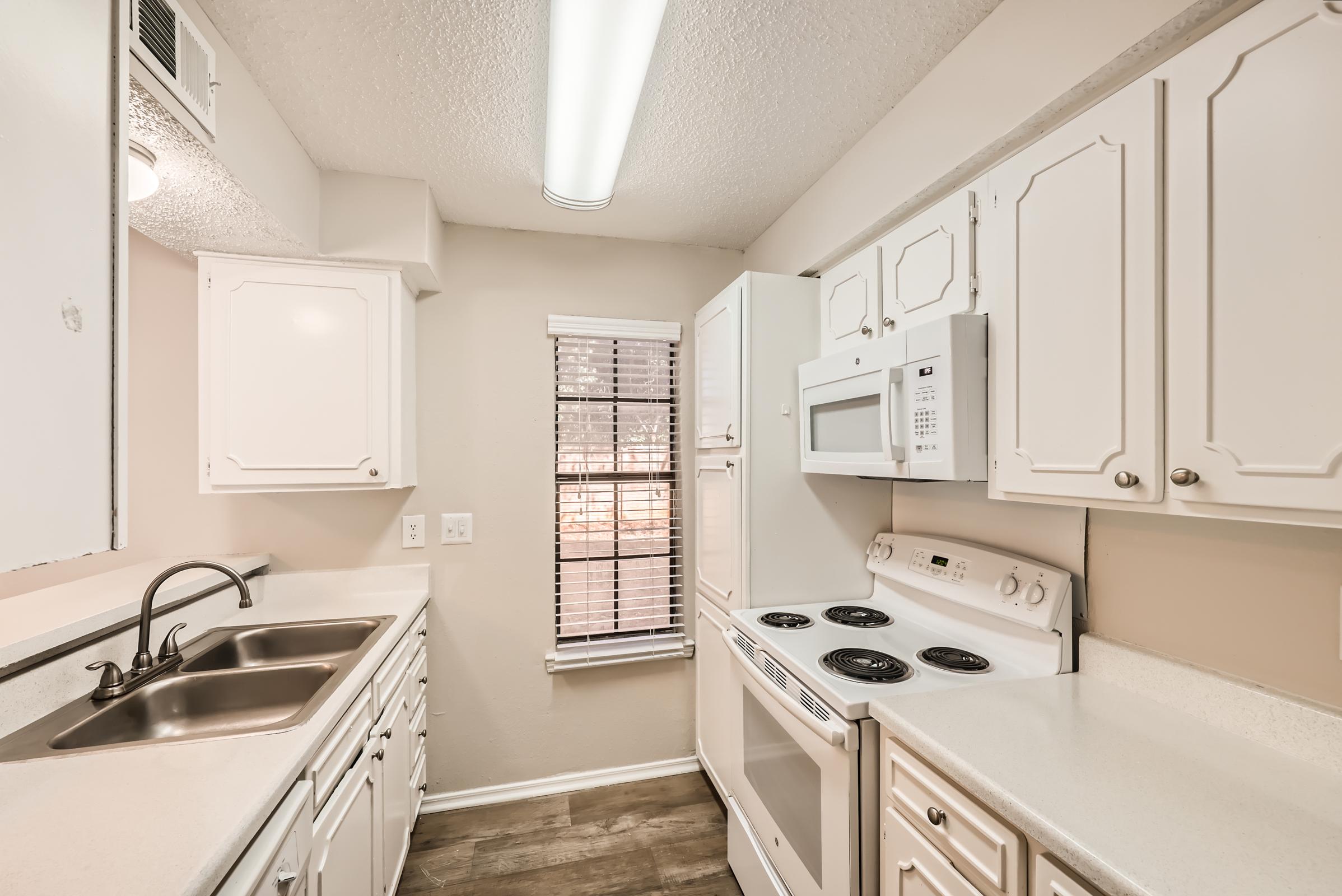 a kitchen with a sink and a microwave