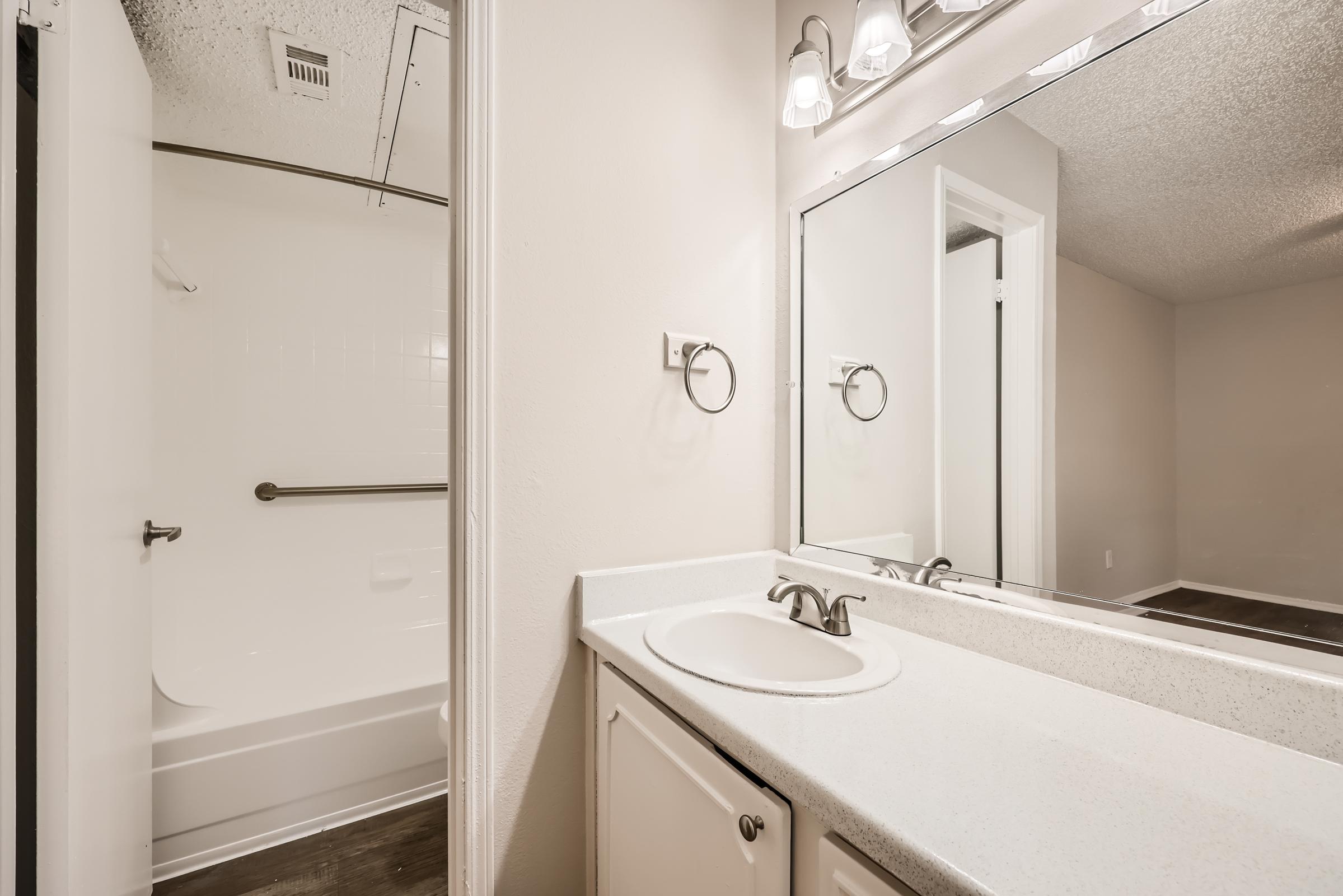 A Rise Oak Creek bathroom with a separate shower room.