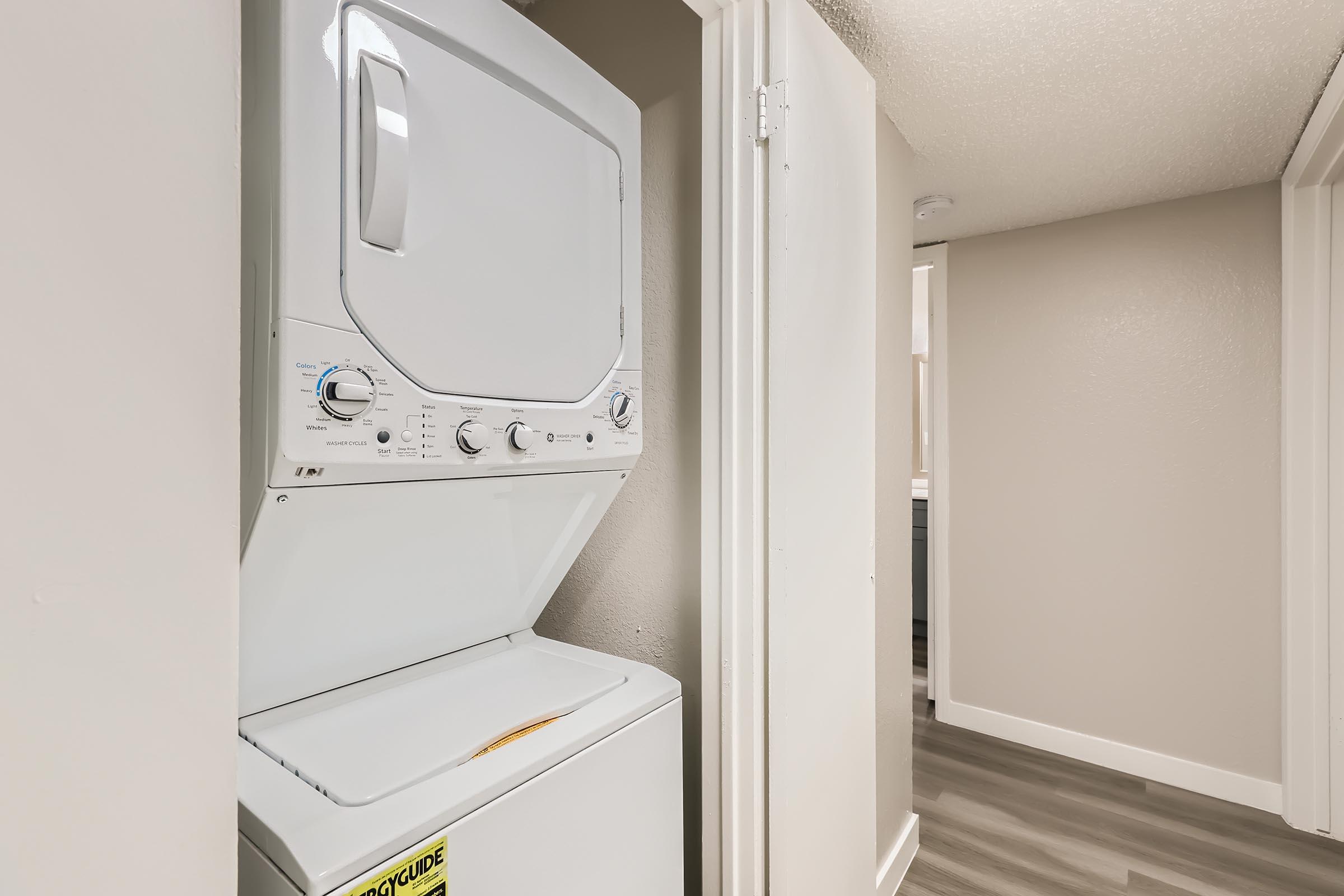 A washer and dryer in a closet at Rise Oak Creek in Bedford, TX.