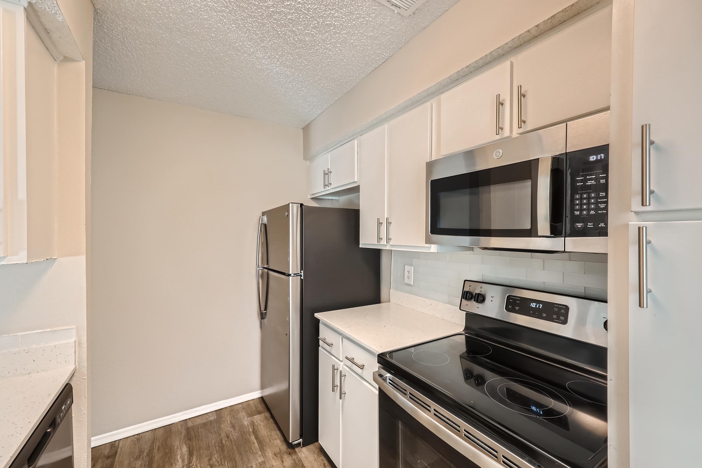 a kitchen with a stove top oven sitting inside of a refrigerator