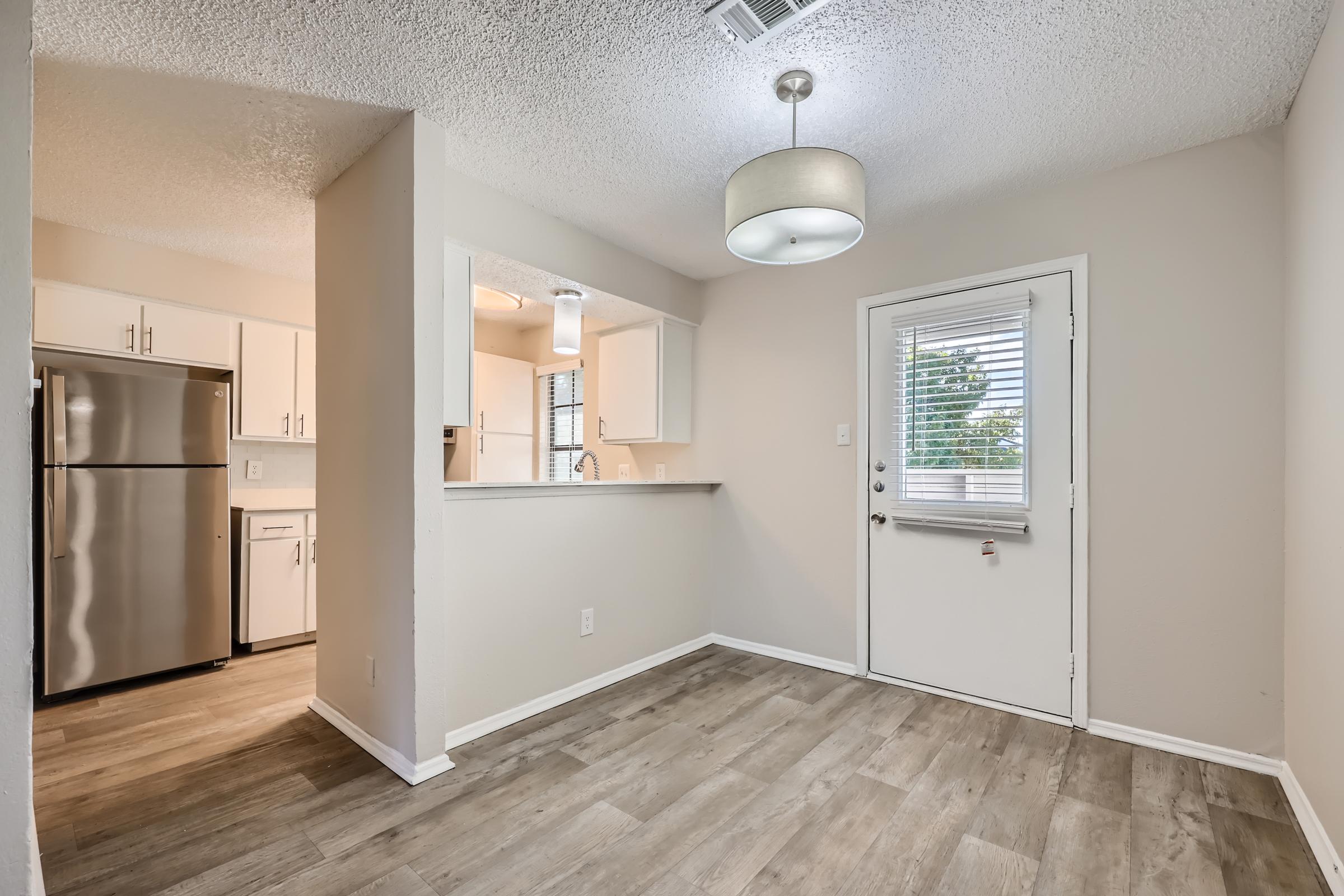 The rear entry into the apartment dining area next to a kitchen at Rise Oak Creek.
