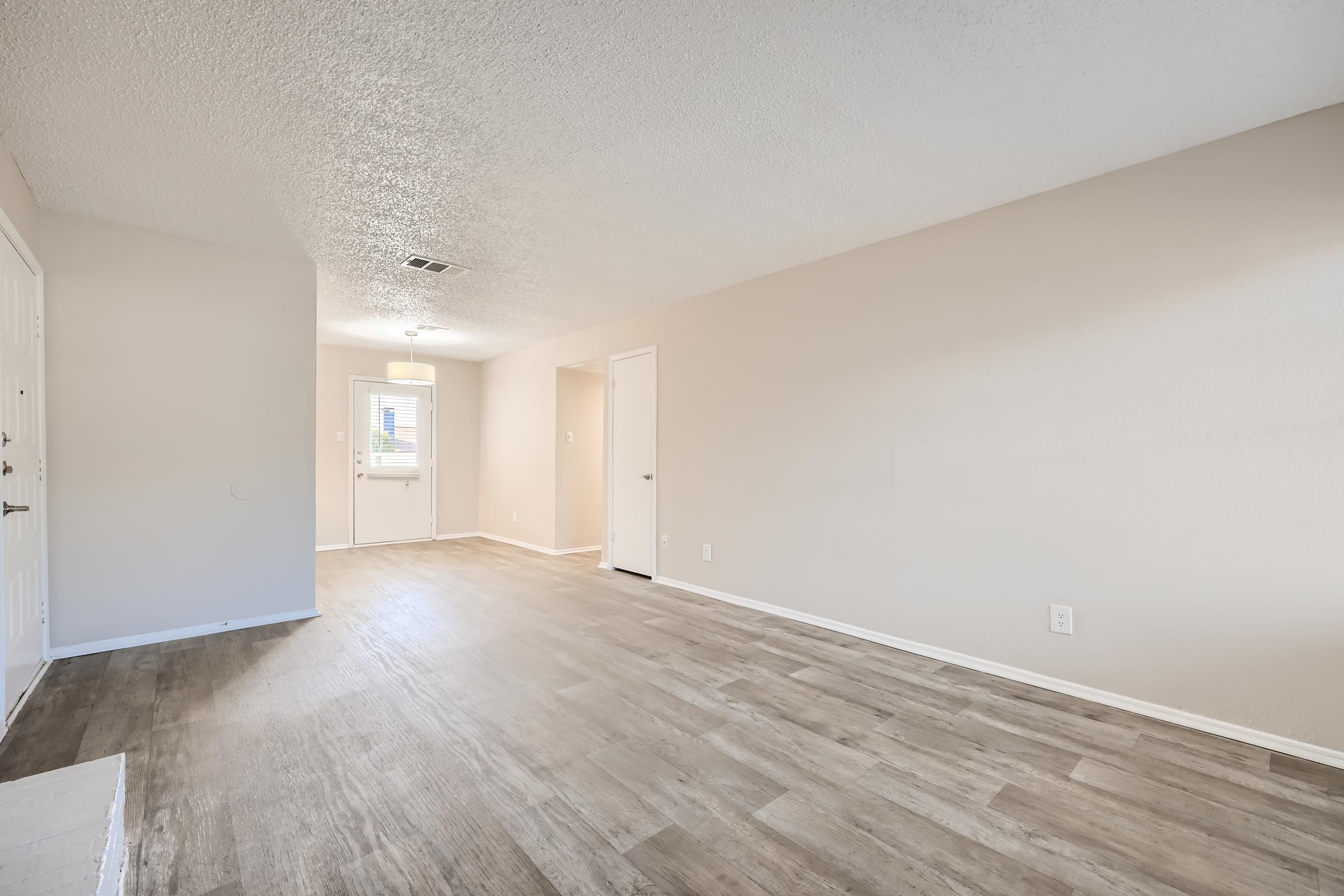 Wood-style flooring leading to the back entrance of an apartment at Rise Oak Creek.