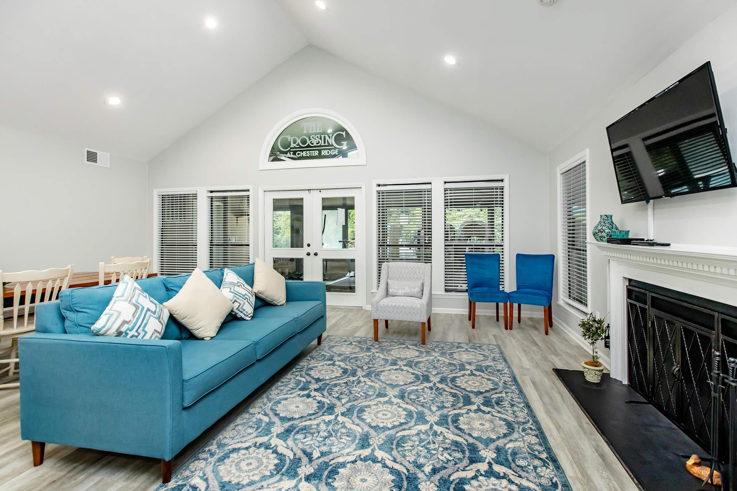 a living room filled with furniture and a large window