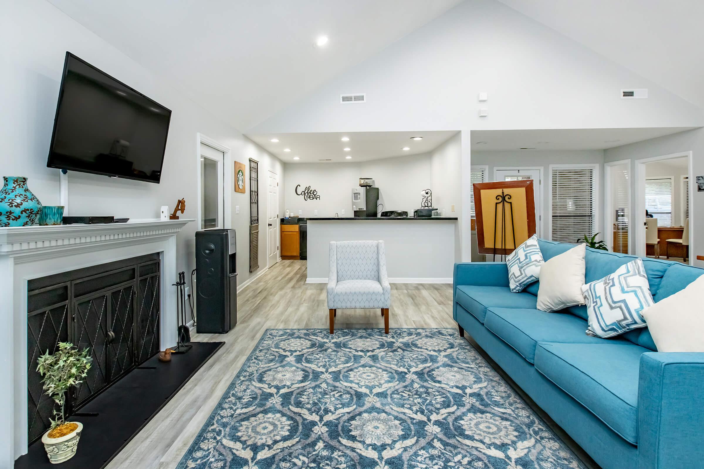 a living room filled with furniture and a flat screen tv