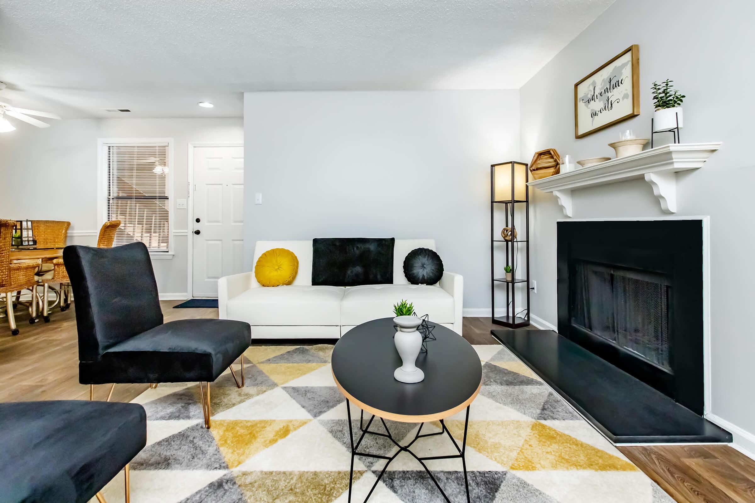 a living room filled with furniture and a fireplace