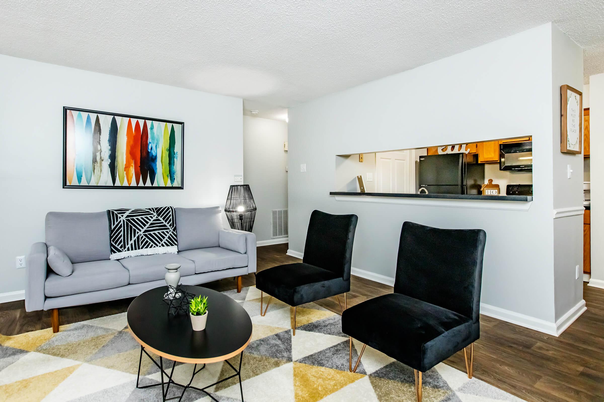 a living room filled with furniture and a flat screen tv