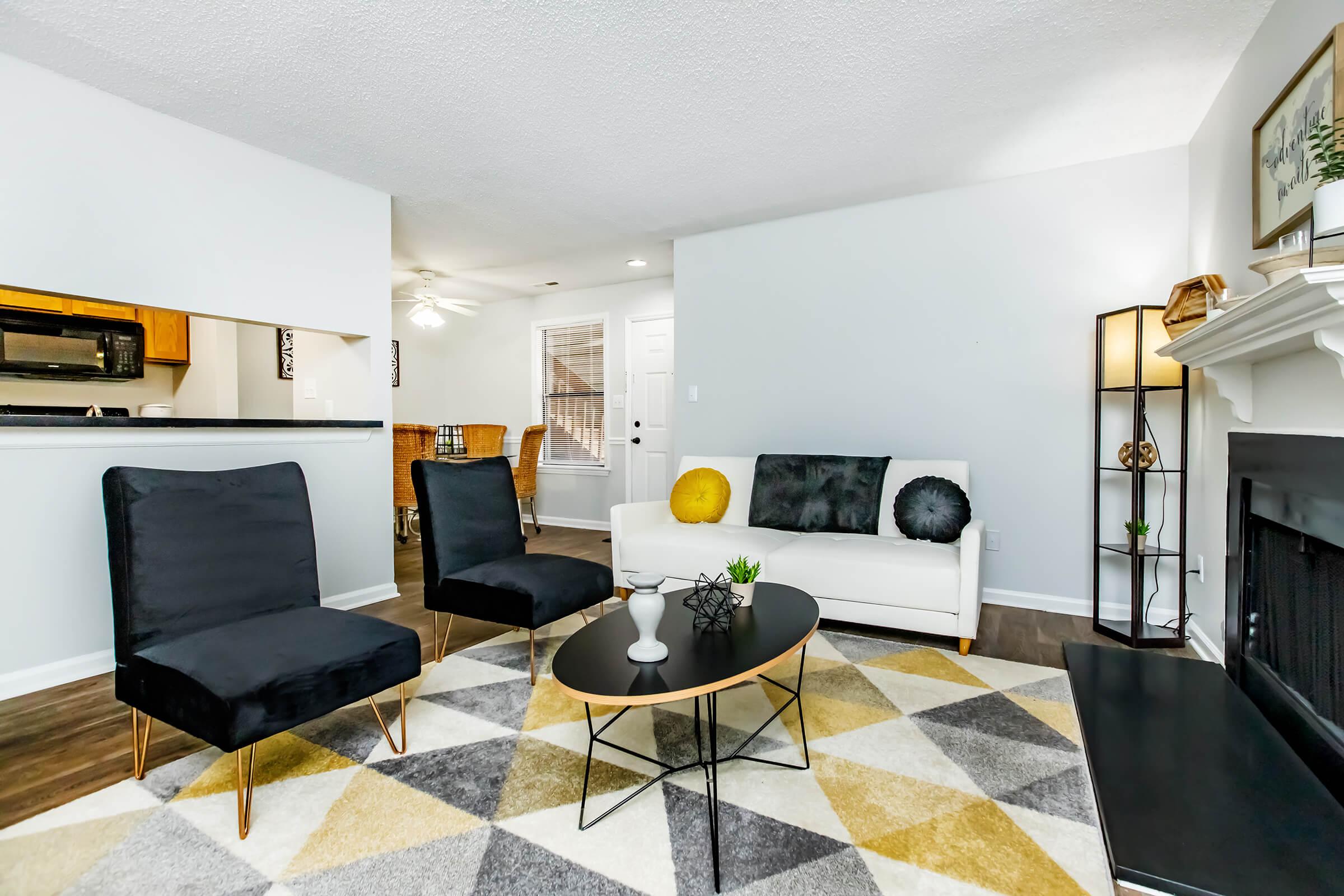 a living room filled with furniture and a rug