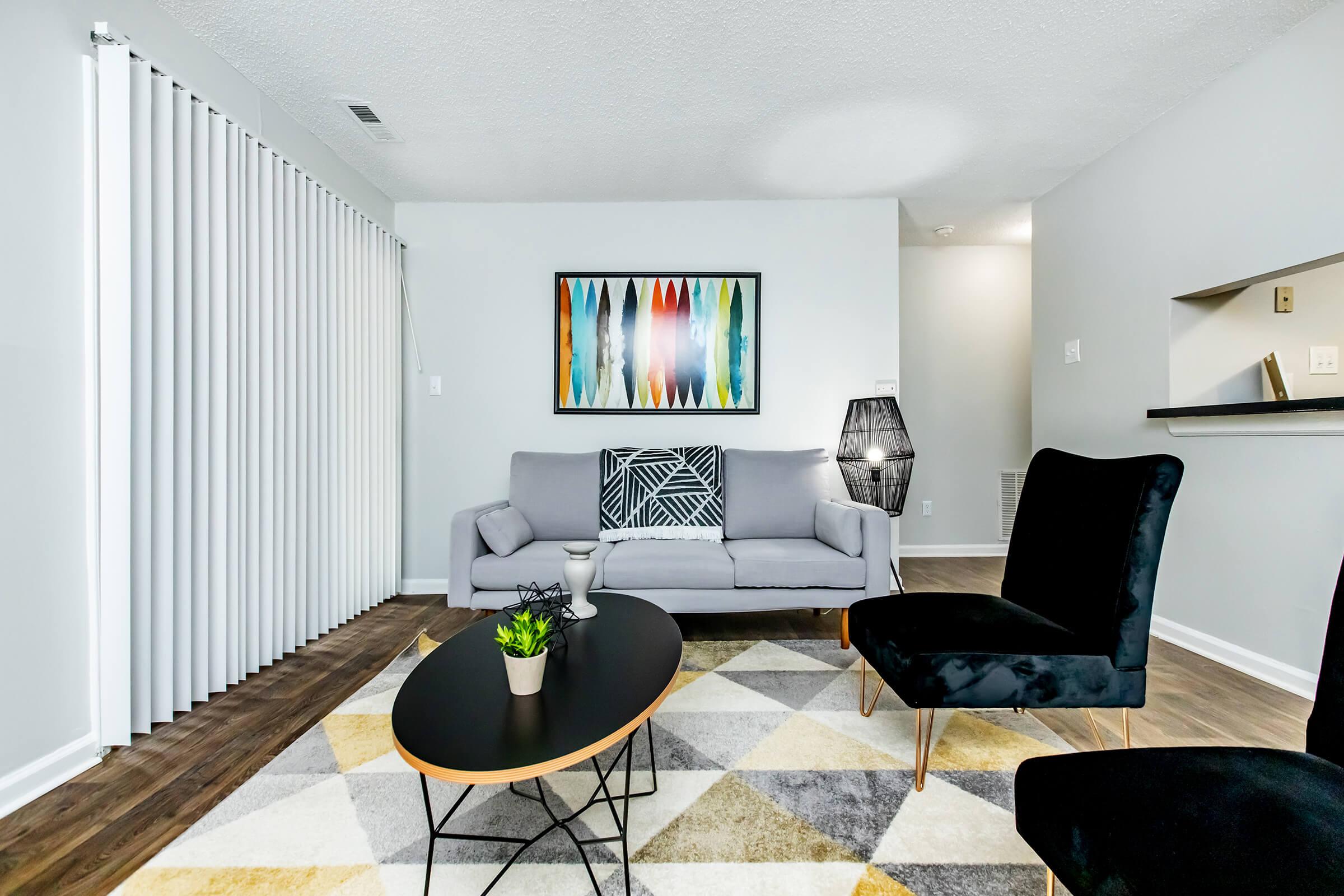 a living room filled with furniture and a flat screen tv