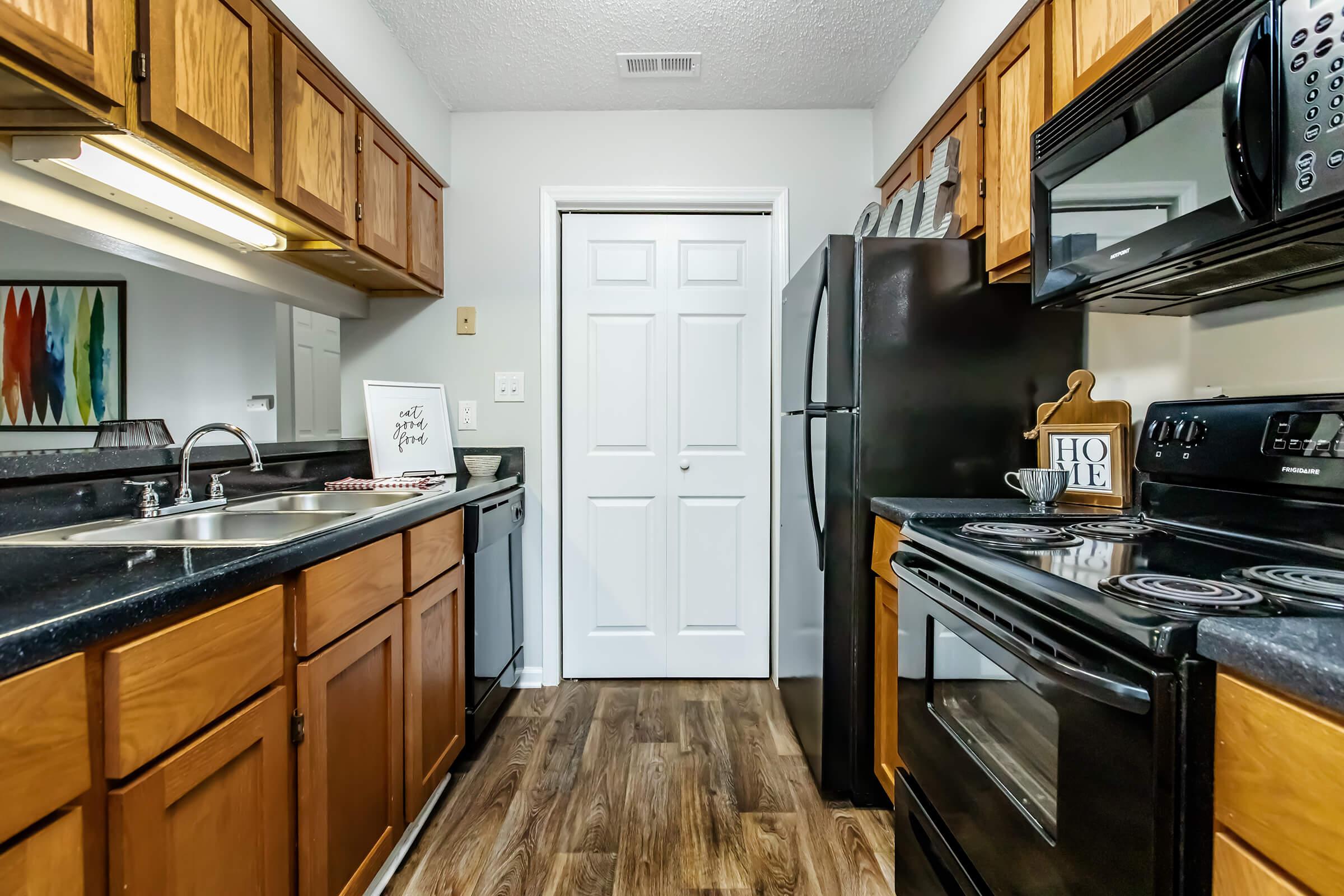 a kitchen with stainless steel appliances and wooden cabinets