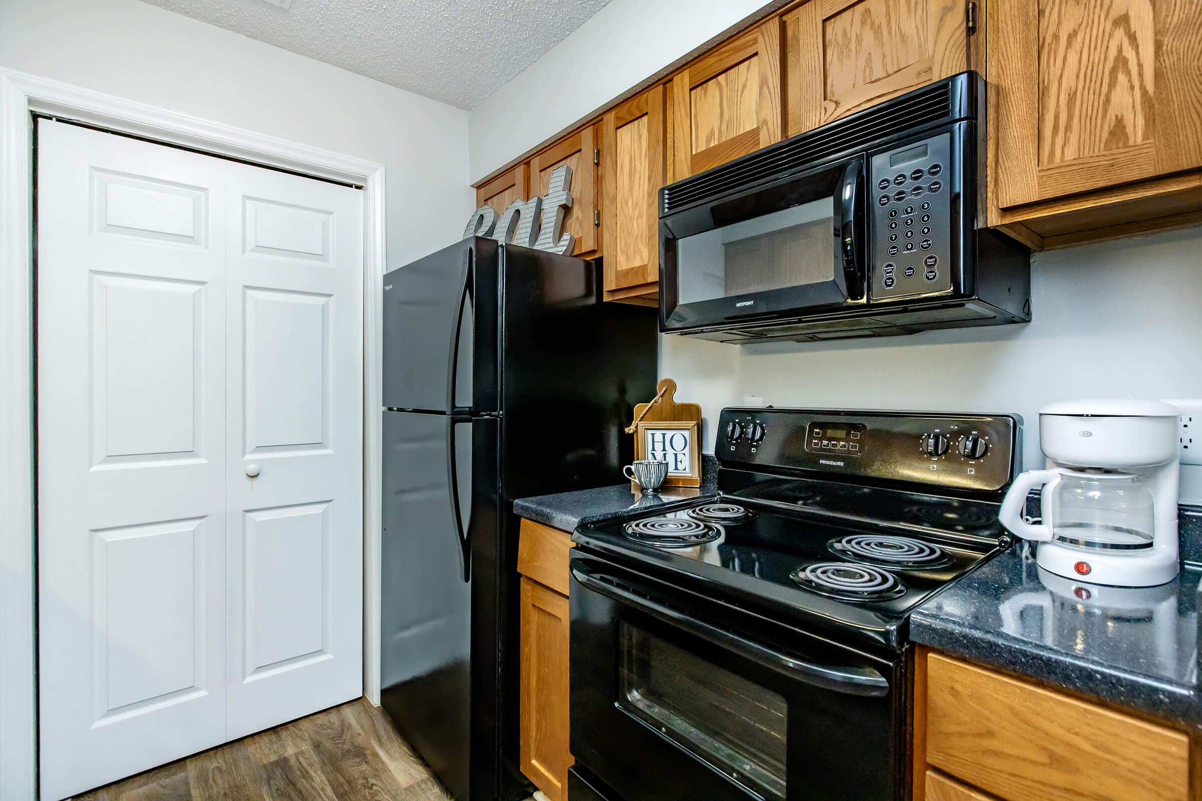 a stove top oven sitting inside of a kitchen