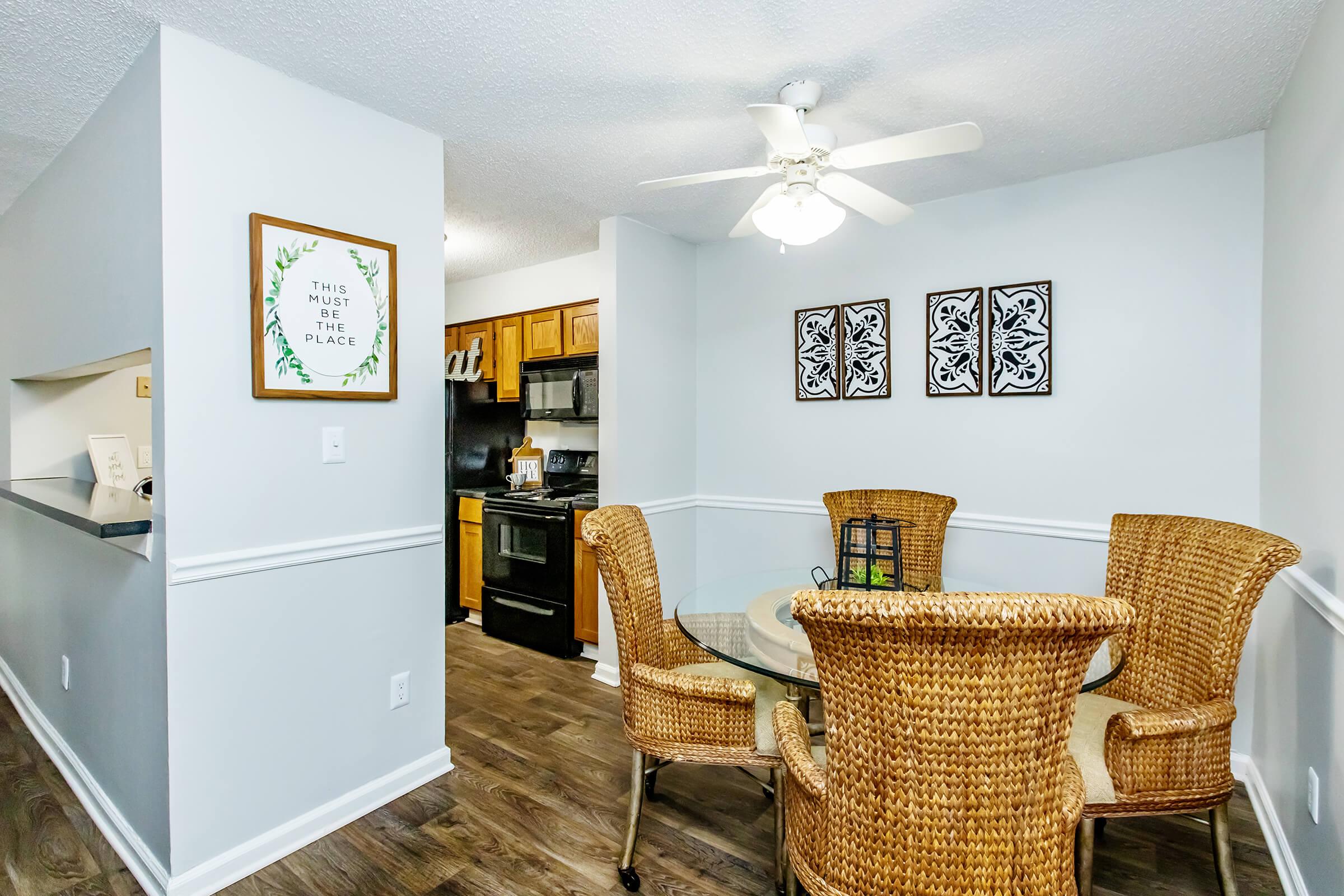 a living room filled with furniture and a refrigerator