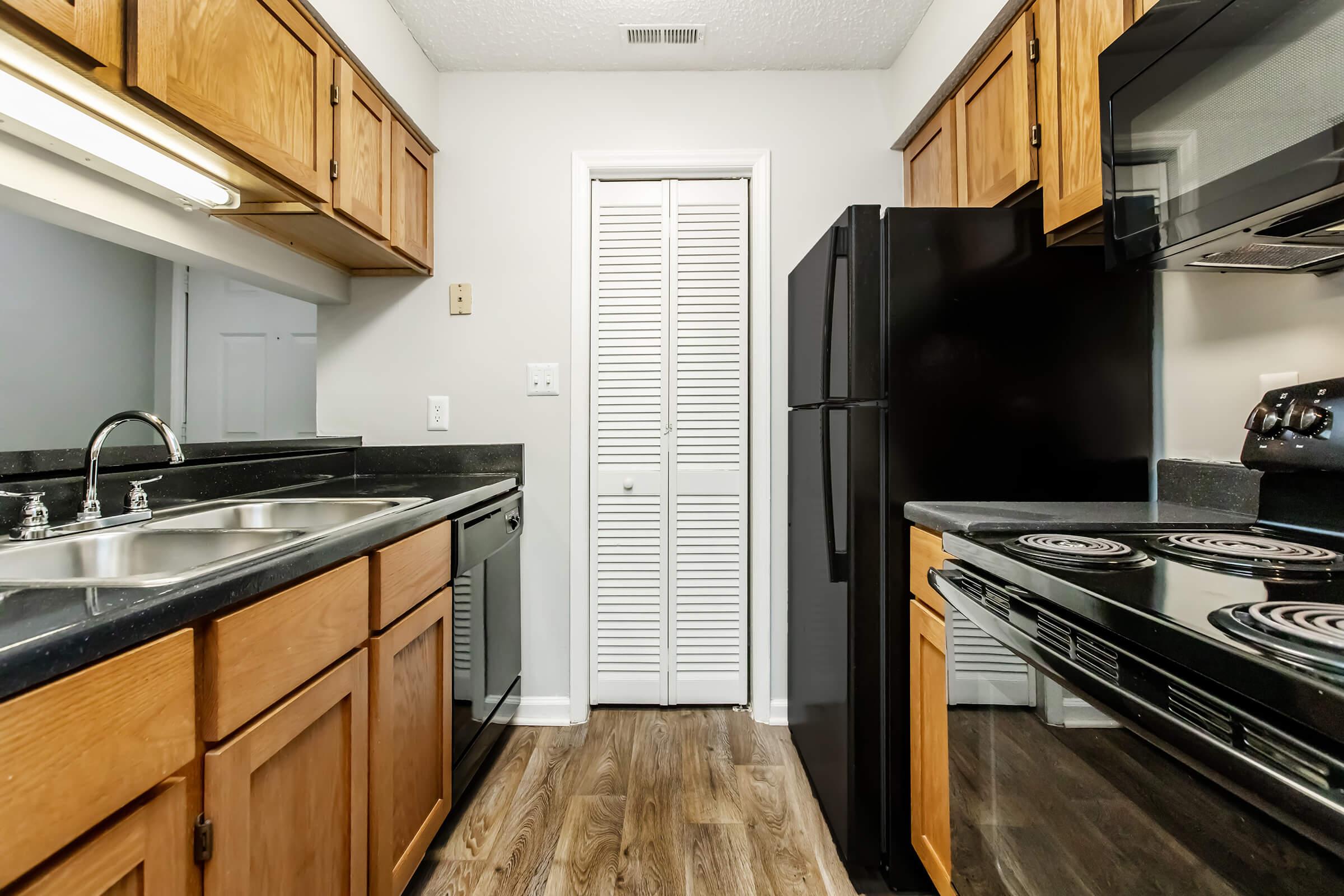 a kitchen with stainless steel appliances and wooden cabinets