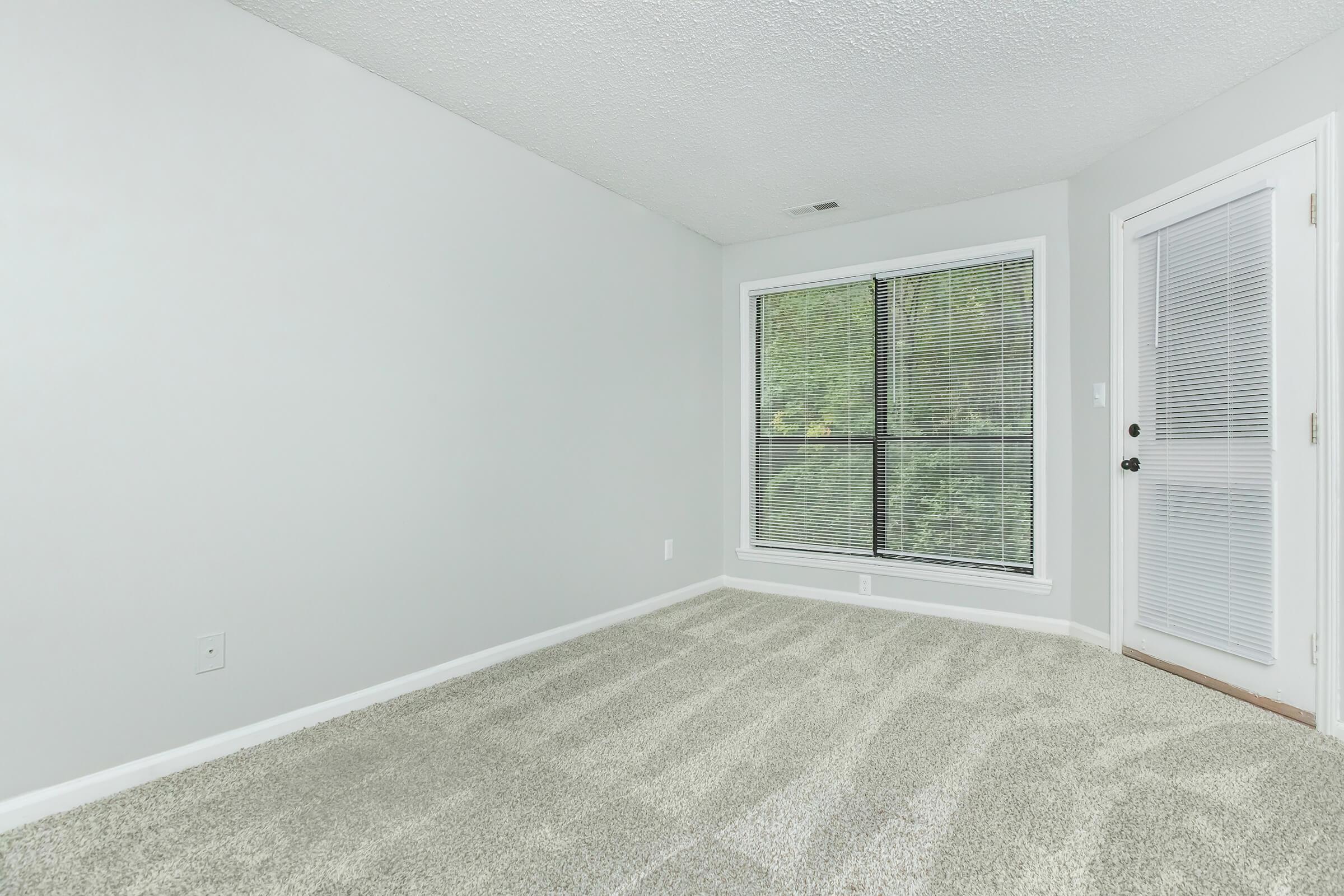 a bedroom with a large window