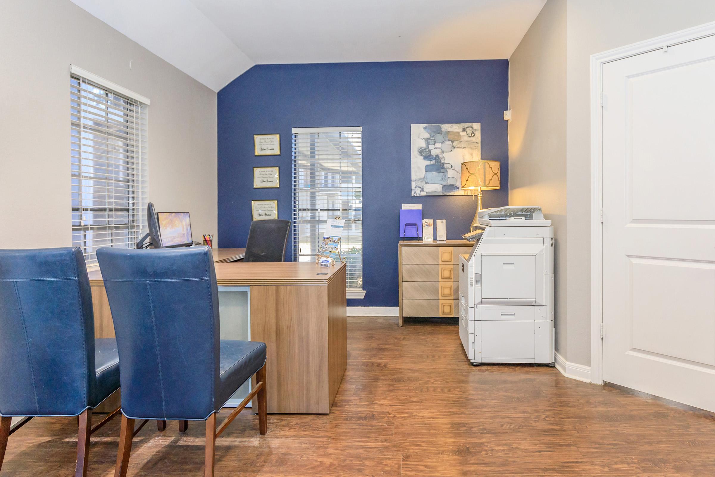 a kitchen with a blue chair