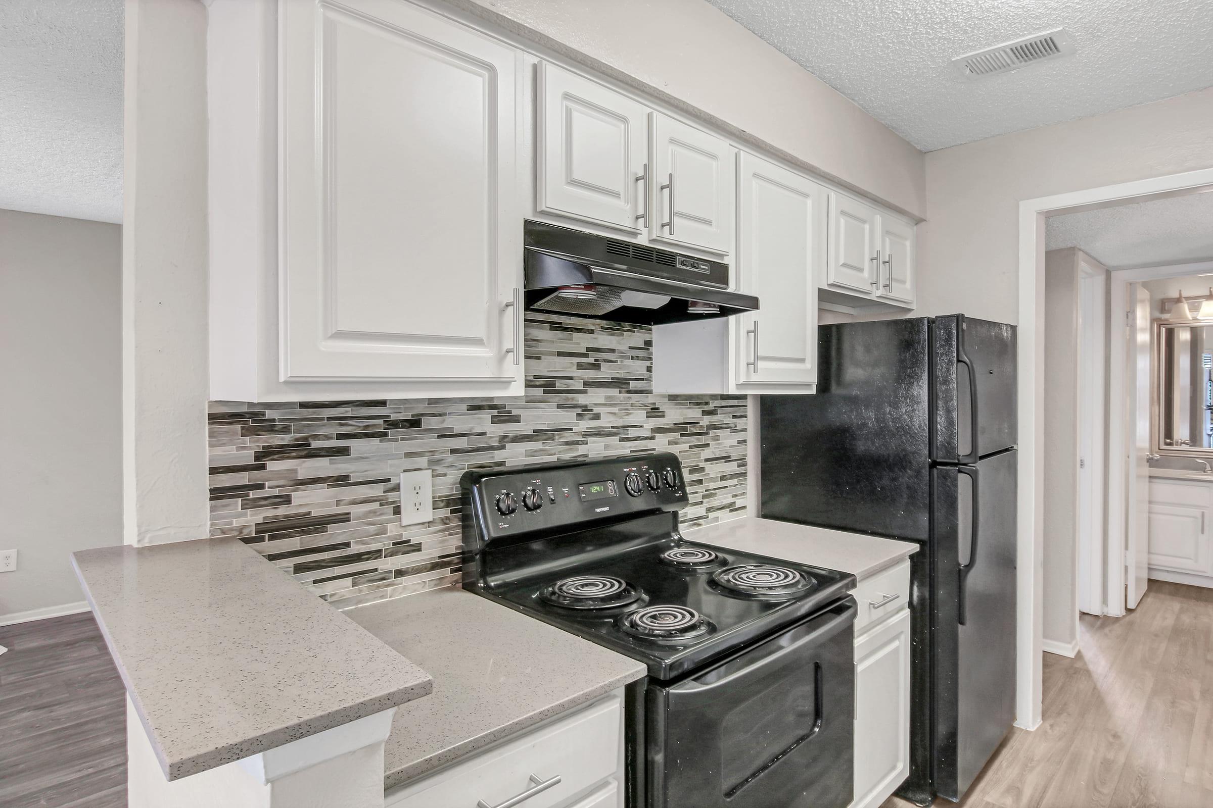 a stove top oven sitting inside of a kitchen