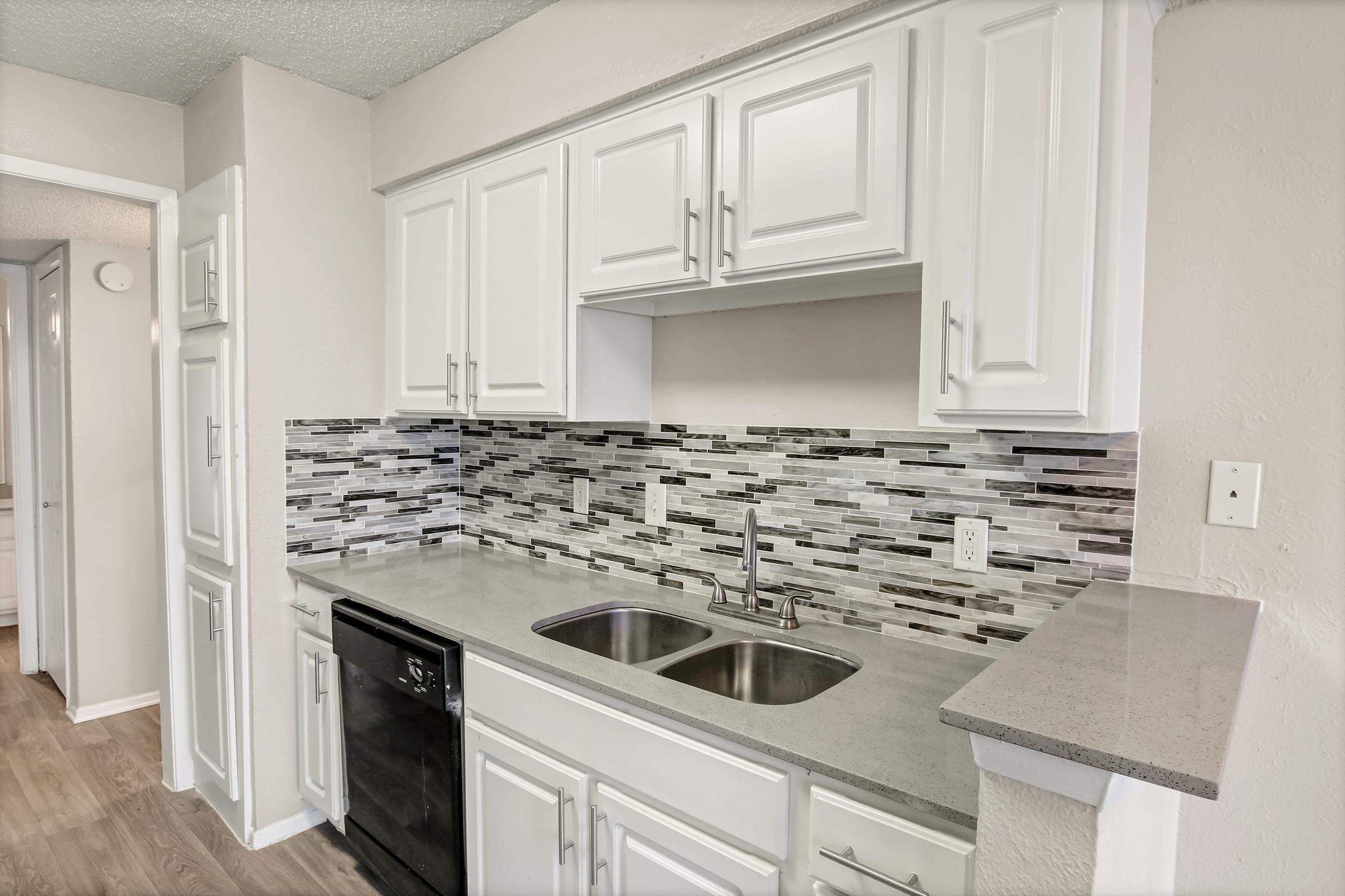 a kitchen with a stove sink and refrigerator