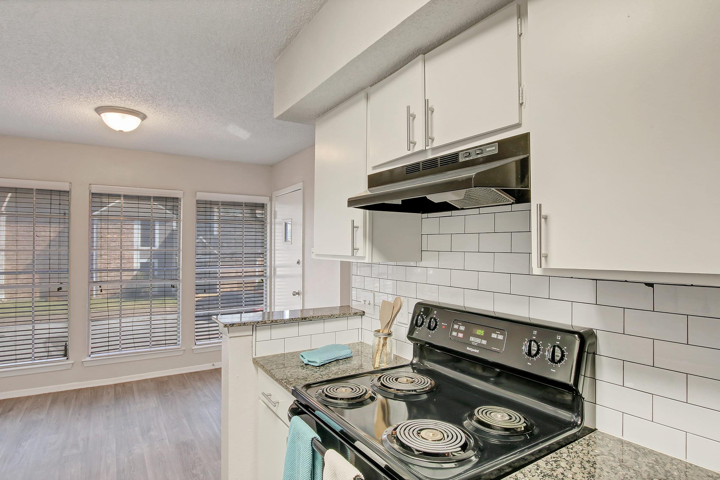 a stove top oven sitting inside of a kitchen