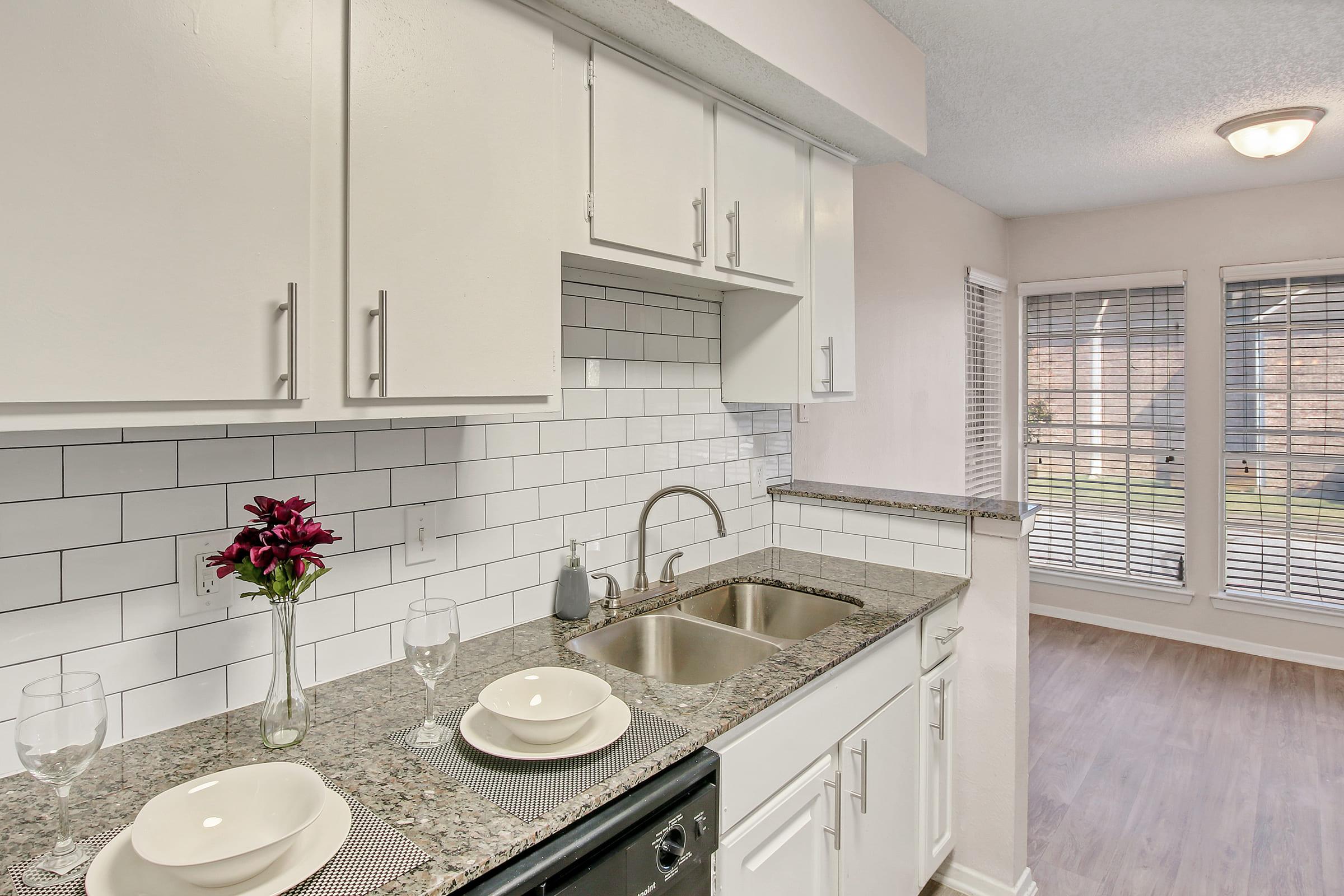 a kitchen with a sink and a mirror