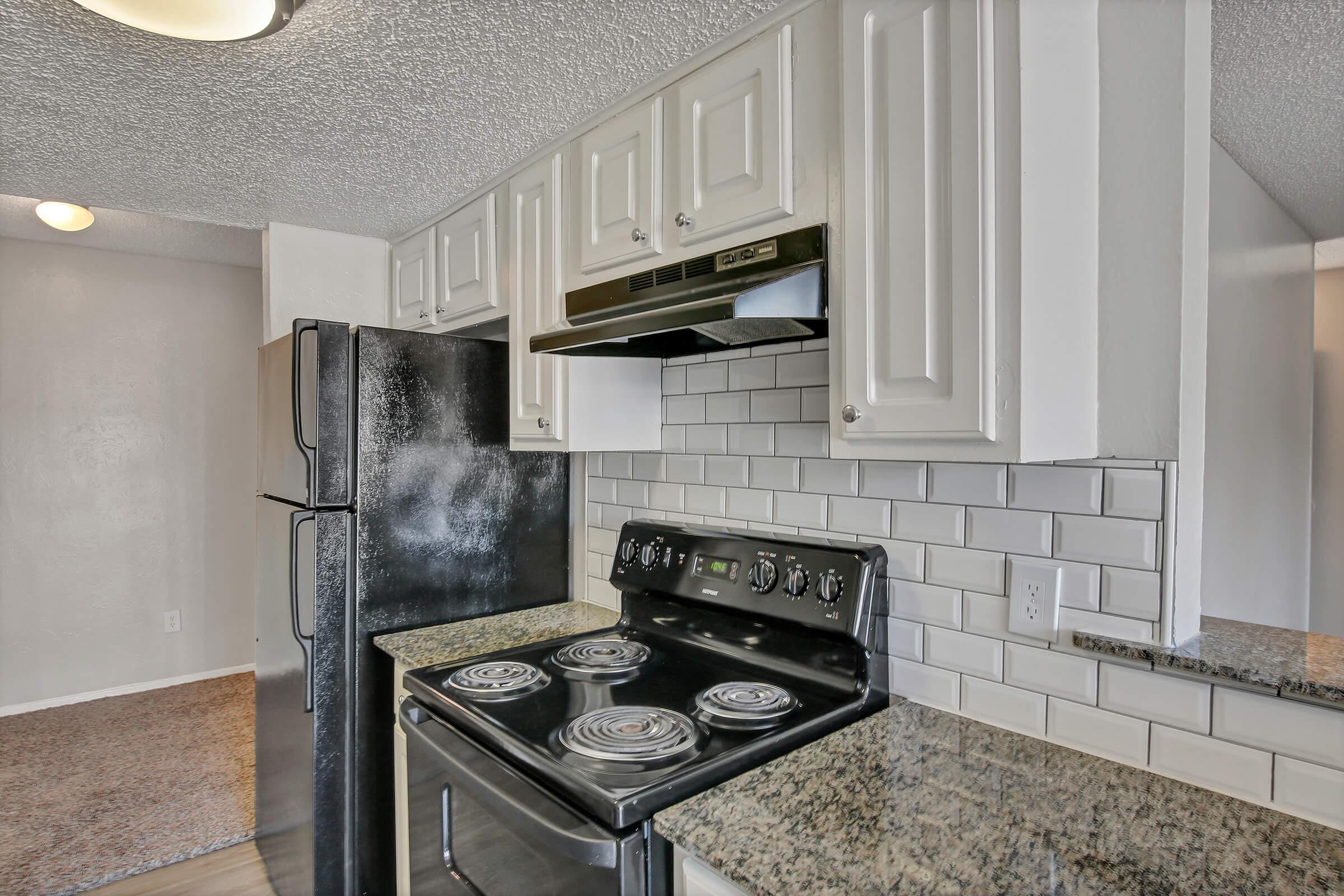 a stove top oven sitting inside of a kitchen