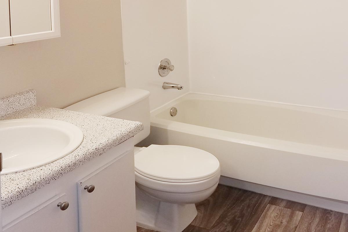 a white tub sitting next to a sink