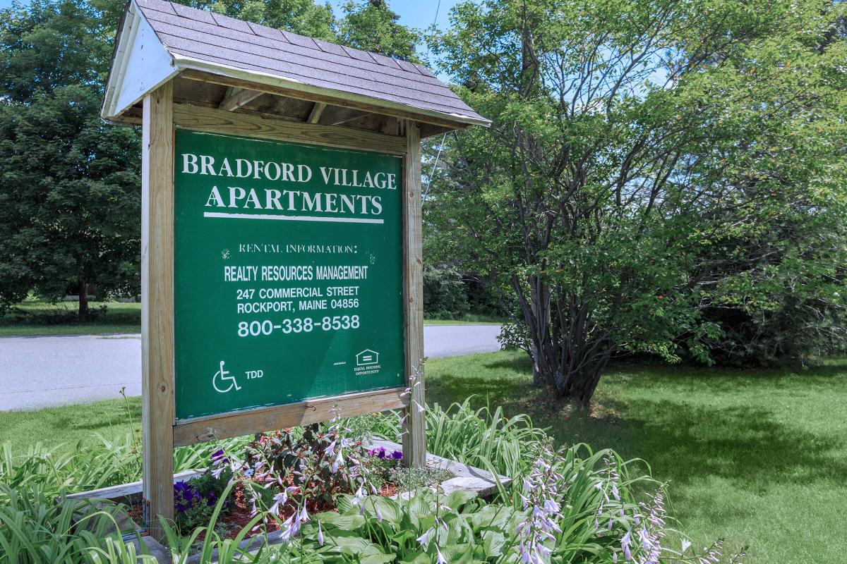 a sign in front of a house