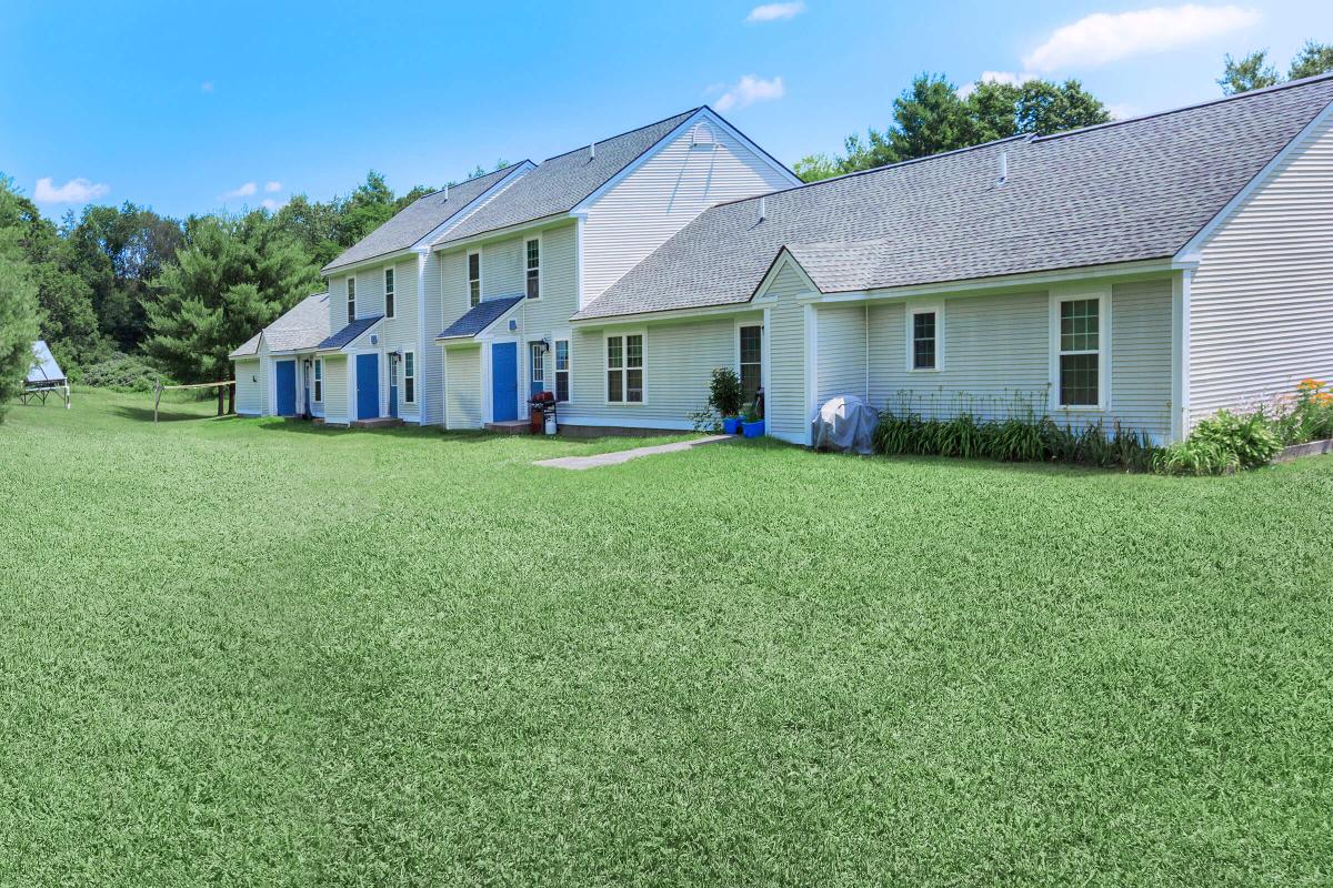 a green lawn in front of a house