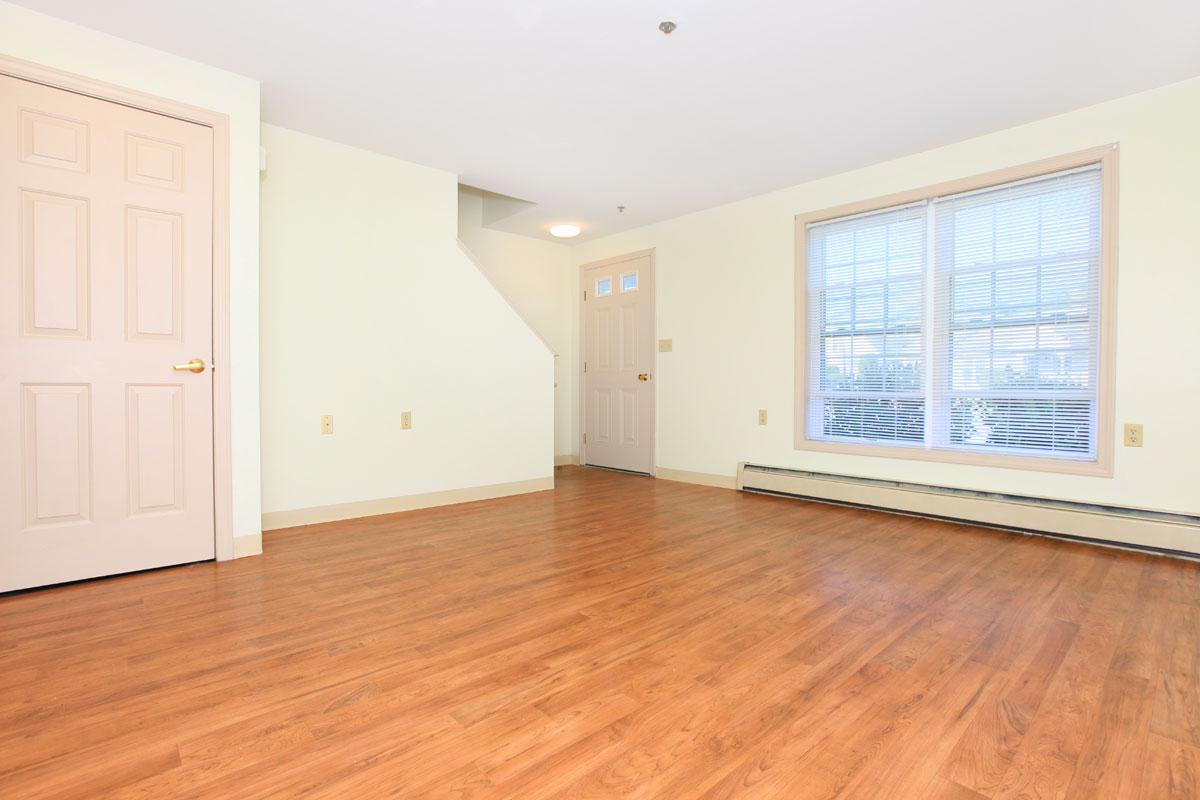 a large empty room with a wood floor