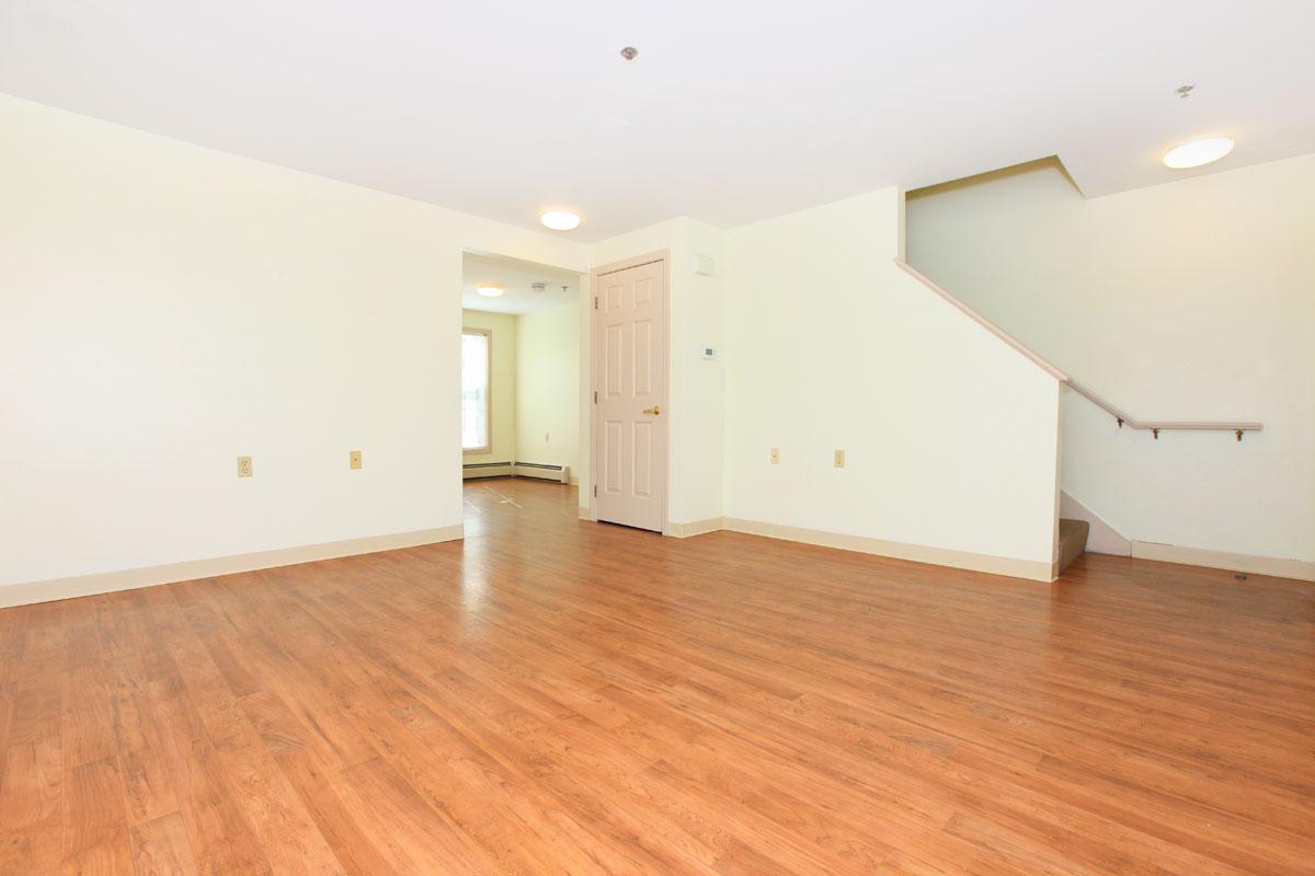 a large empty room with a hard wood floor