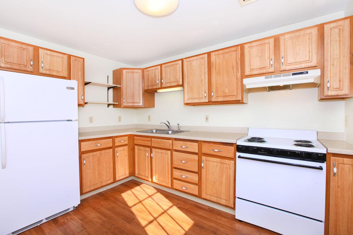 a kitchen with stainless steel appliances and wooden cabinets