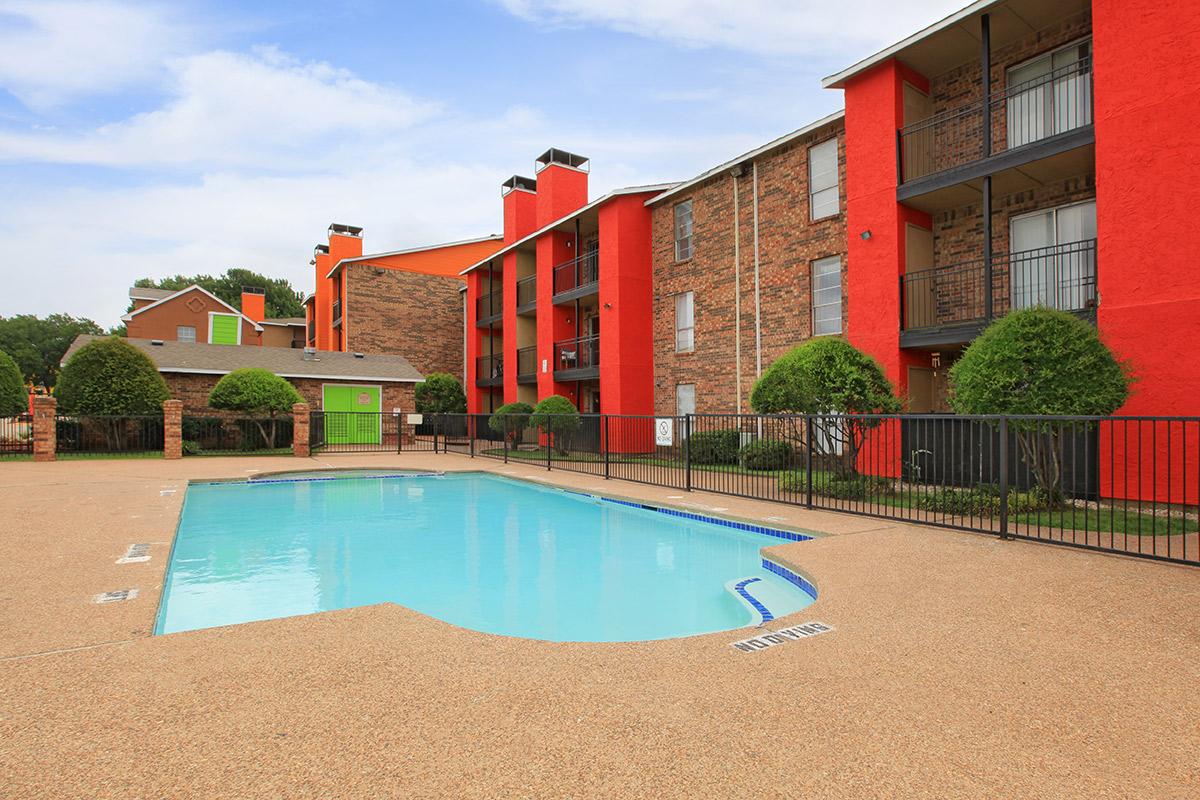 a house with a pool outside of a building