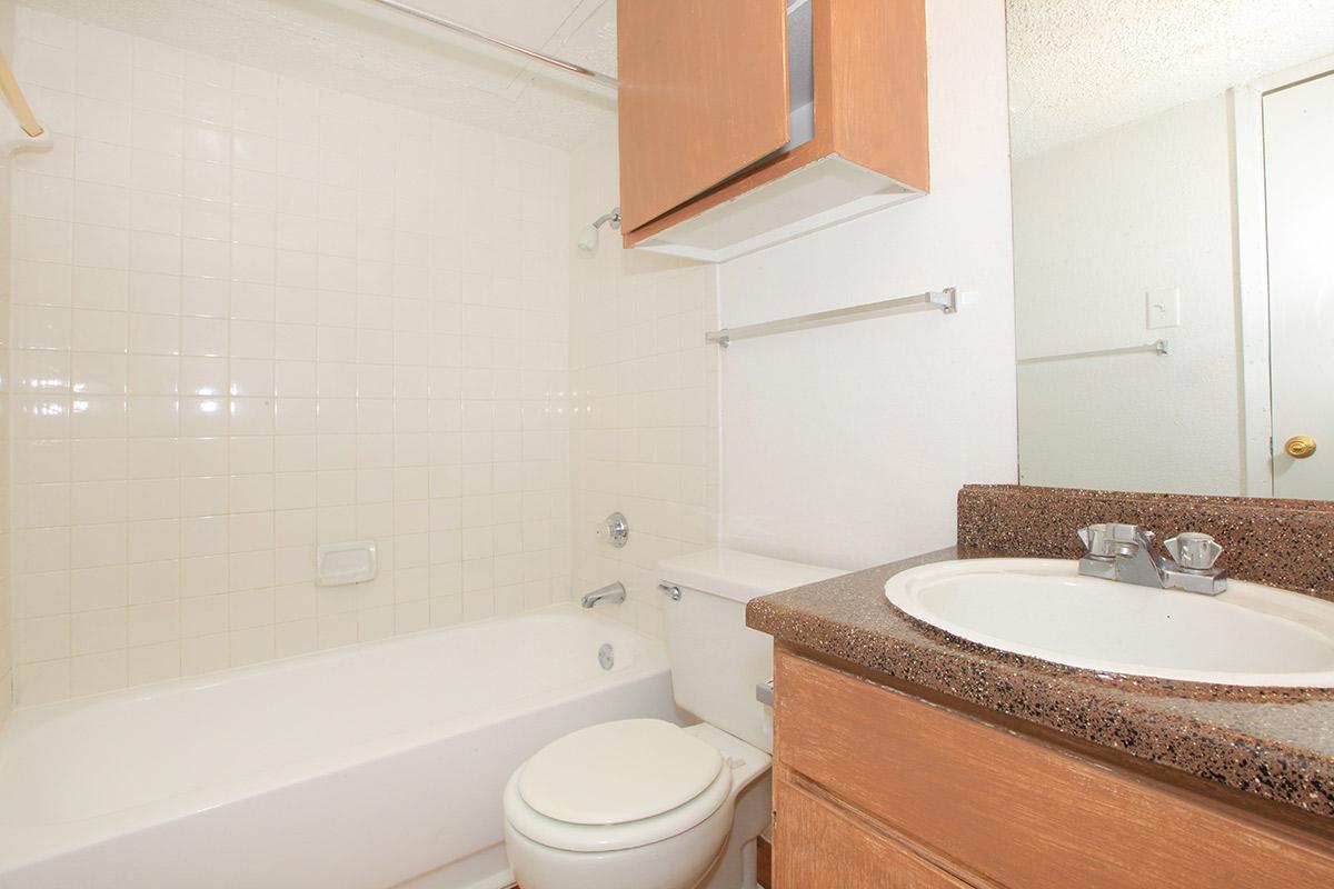 a white tub sitting next to a sink