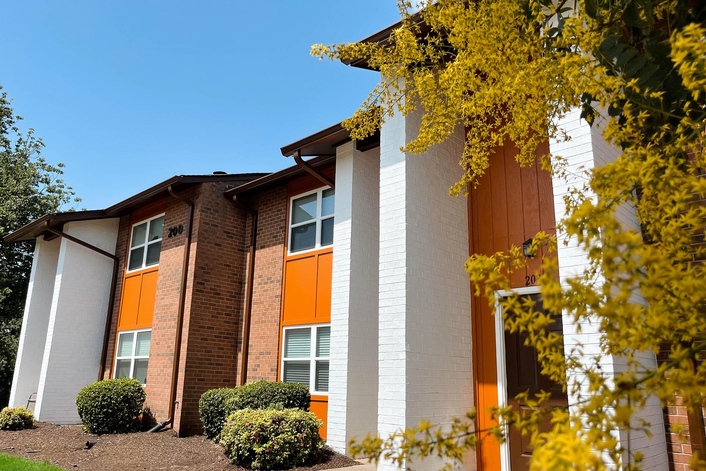 a house with bushes in front of a building