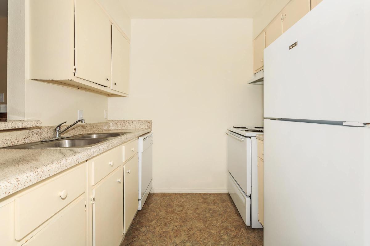 a kitchen with a sink and a refrigerator