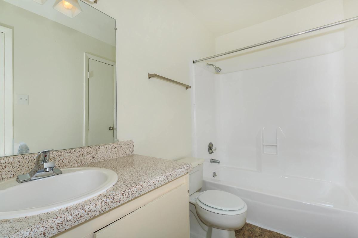 a white sink and a mirror