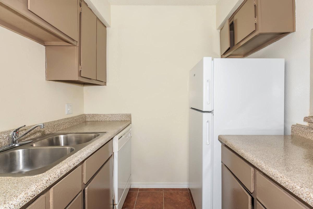 a kitchen with a stove sink and refrigerator