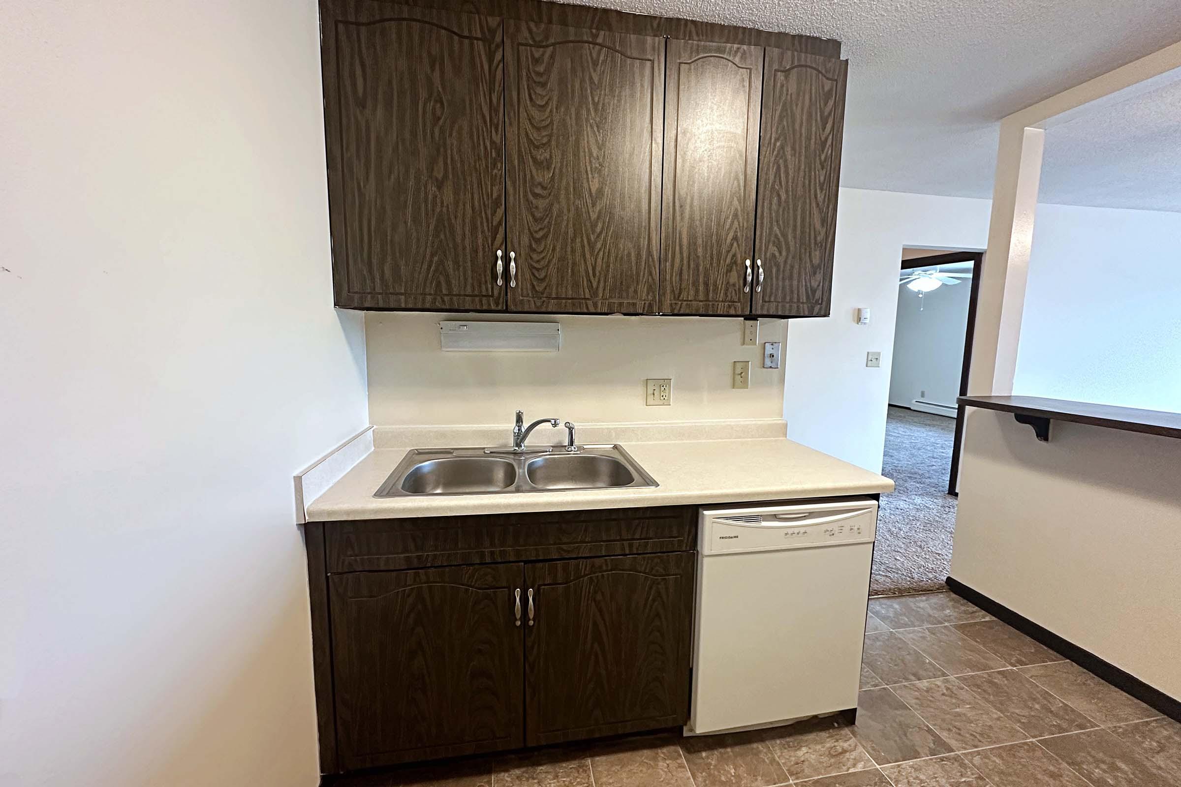 a kitchen with a sink and a mirror