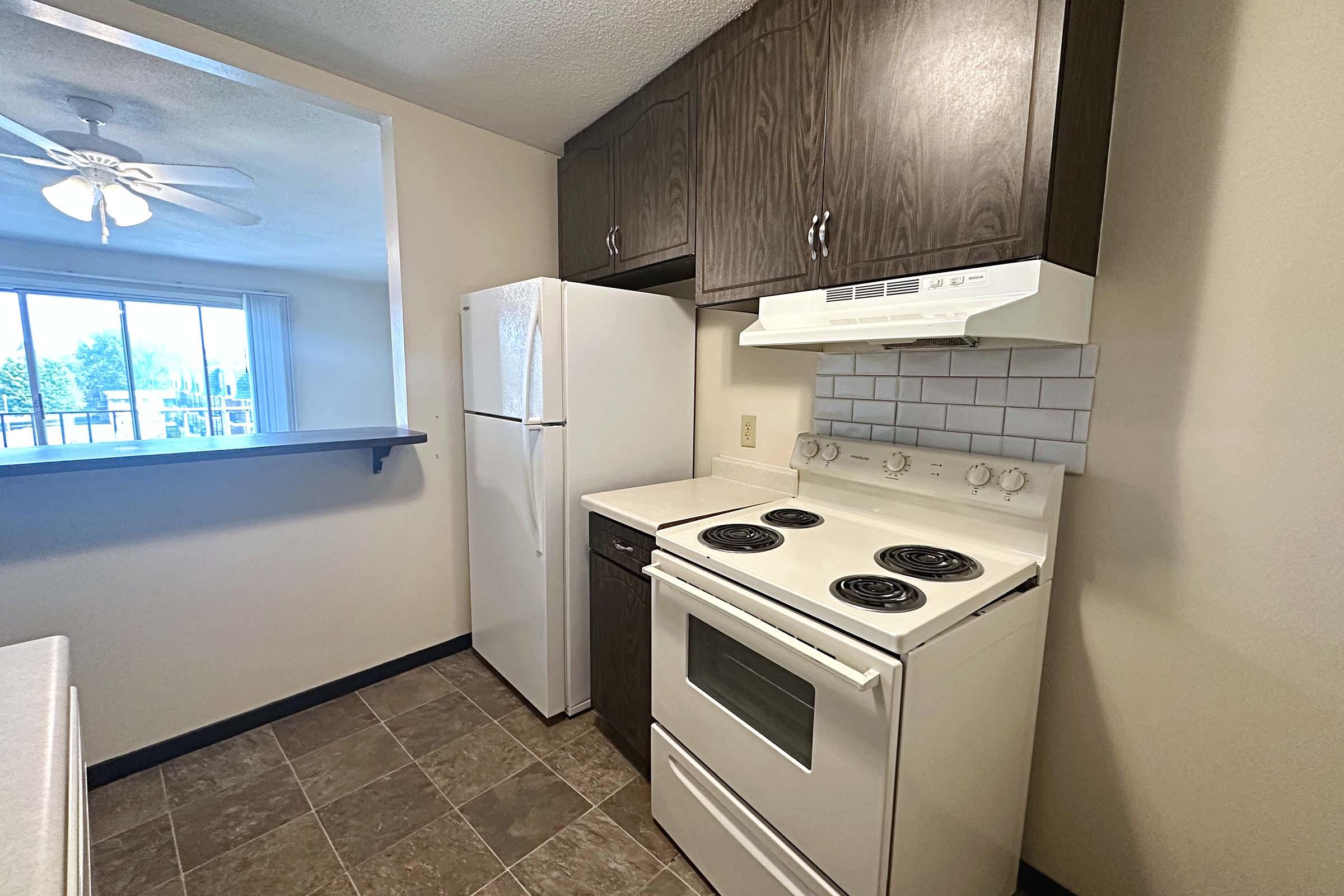 a stove top oven sitting inside of a kitchen