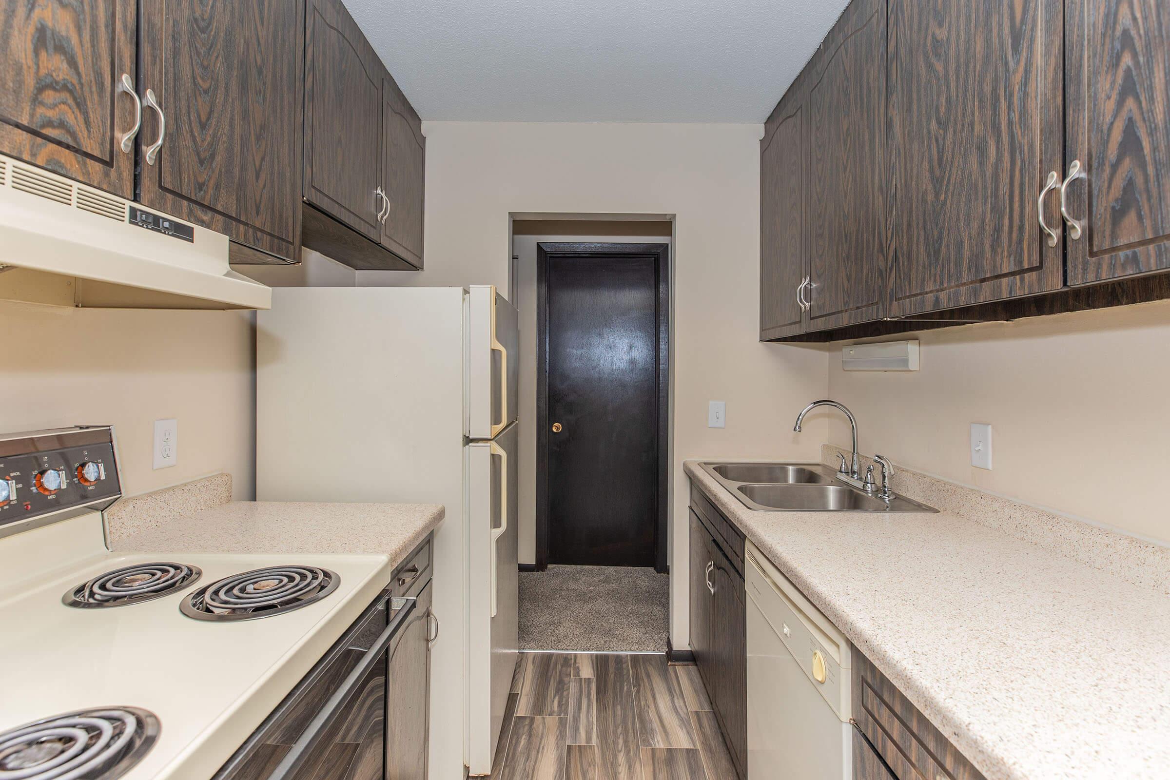 a kitchen with a stove sink and refrigerator