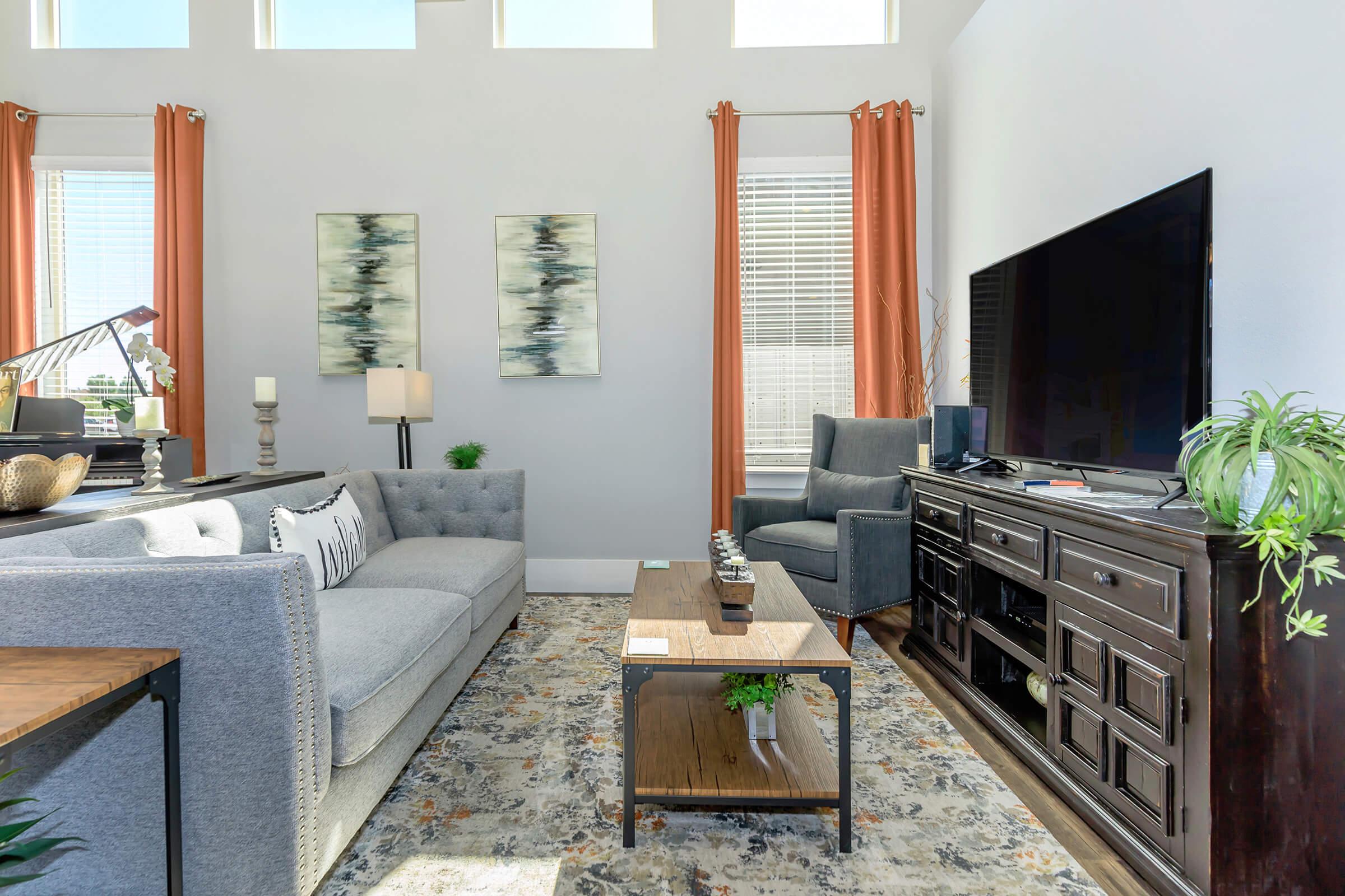 a living room filled with furniture and a large window