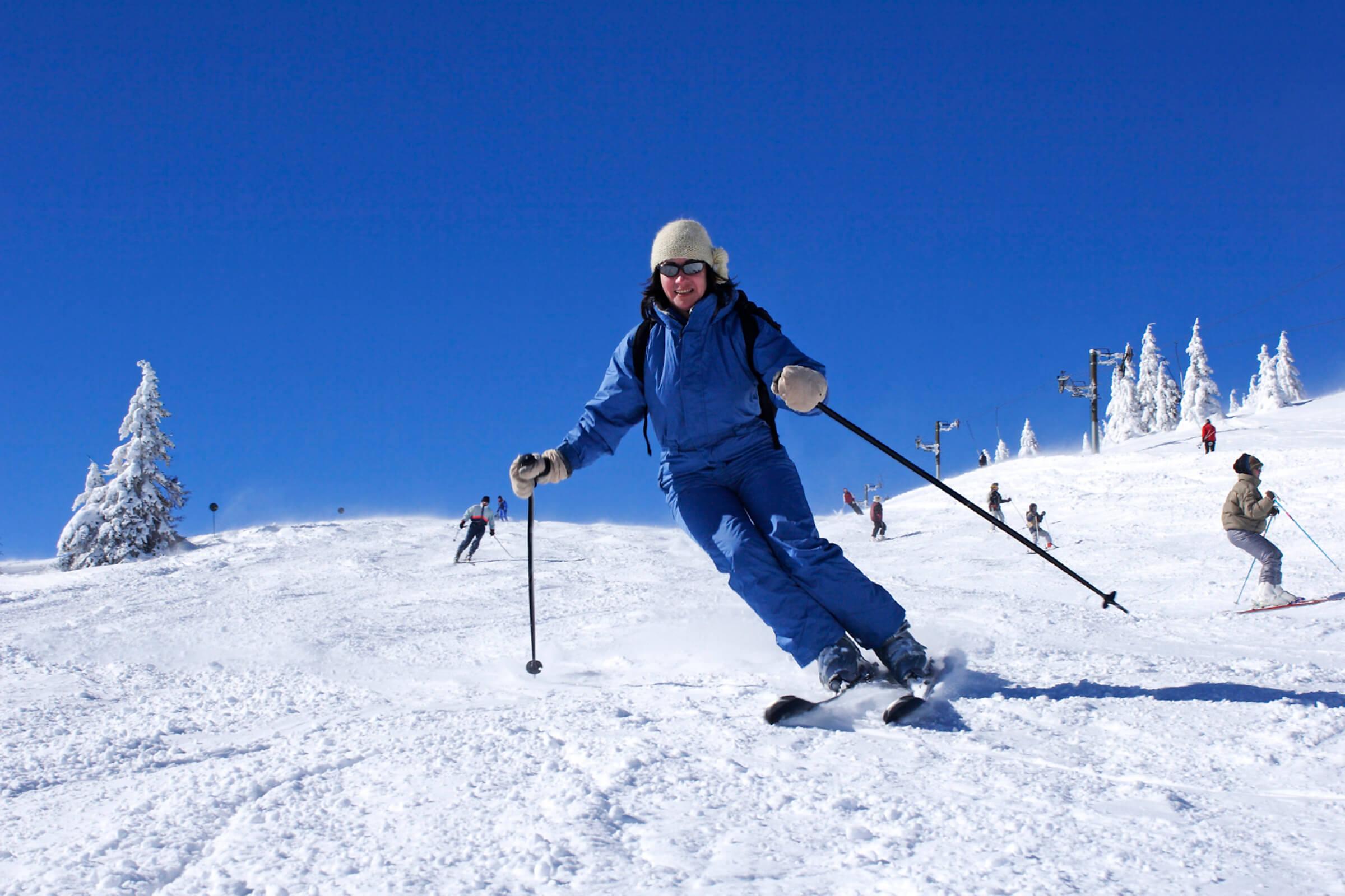 a person riding skis down a snow covered slope