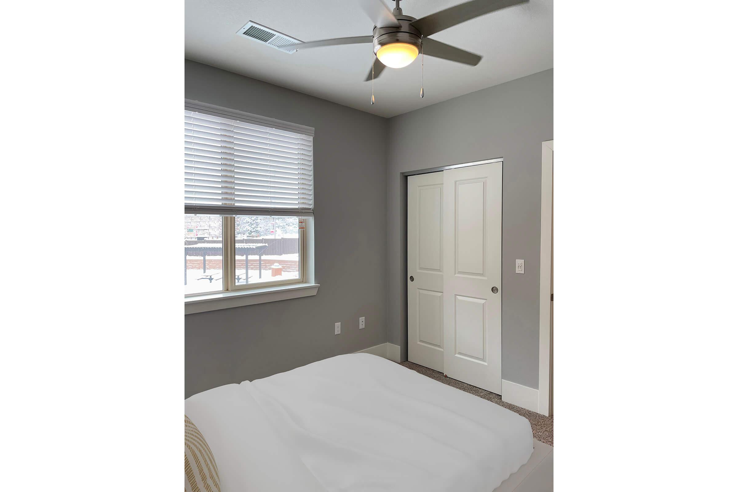 a bedroom with a large window